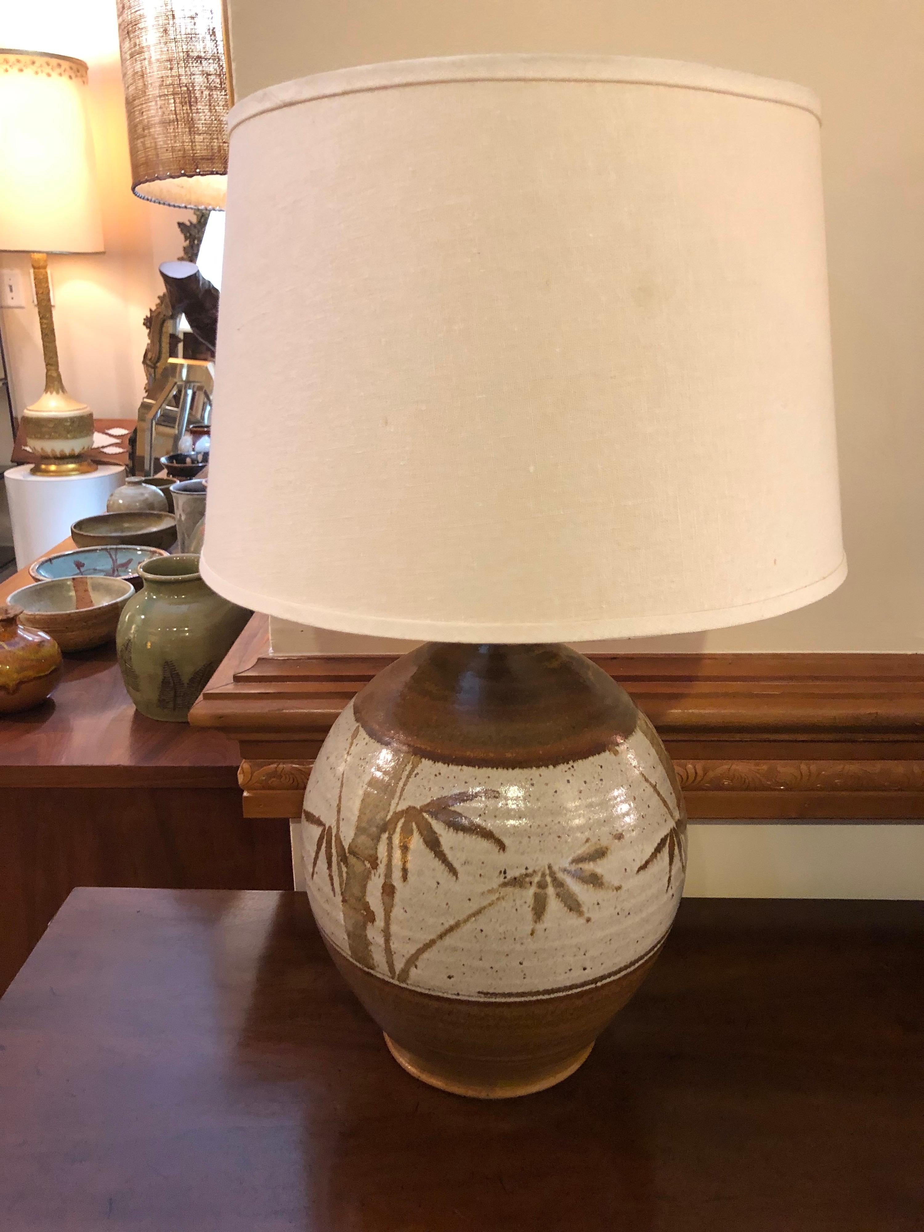 Ceramic bamboo table lamp with shade. Nice bulbous shape with earthones of brown and white. Drum shade to complement on top.