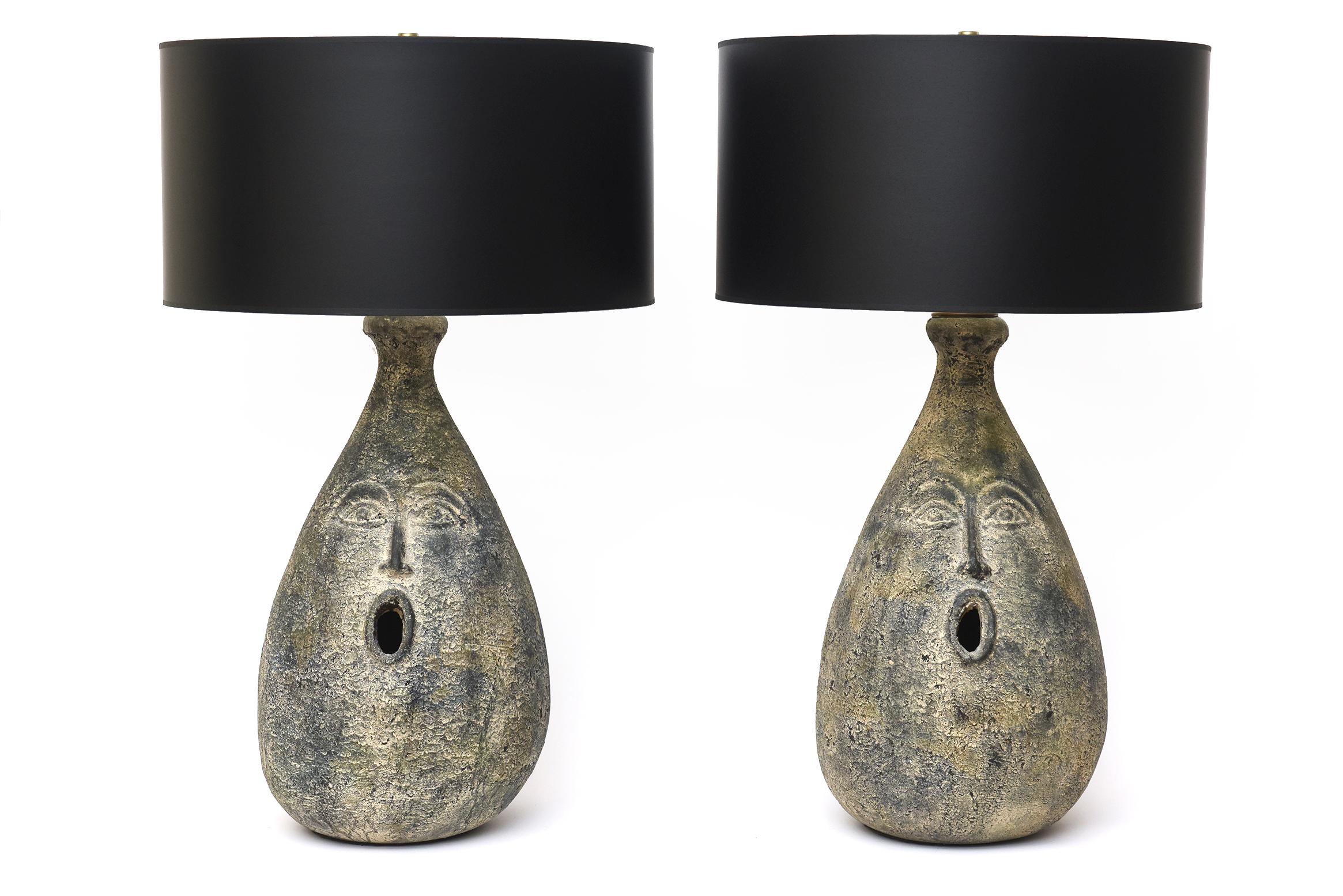 These amazing pair of French Mid-Century Modern face ceramic table or bedside lamps are conversational and very sophisticated. They are from the late 50's or early 60's. They are oh so clever in their subject matter and have a bit of whimsy mixed in