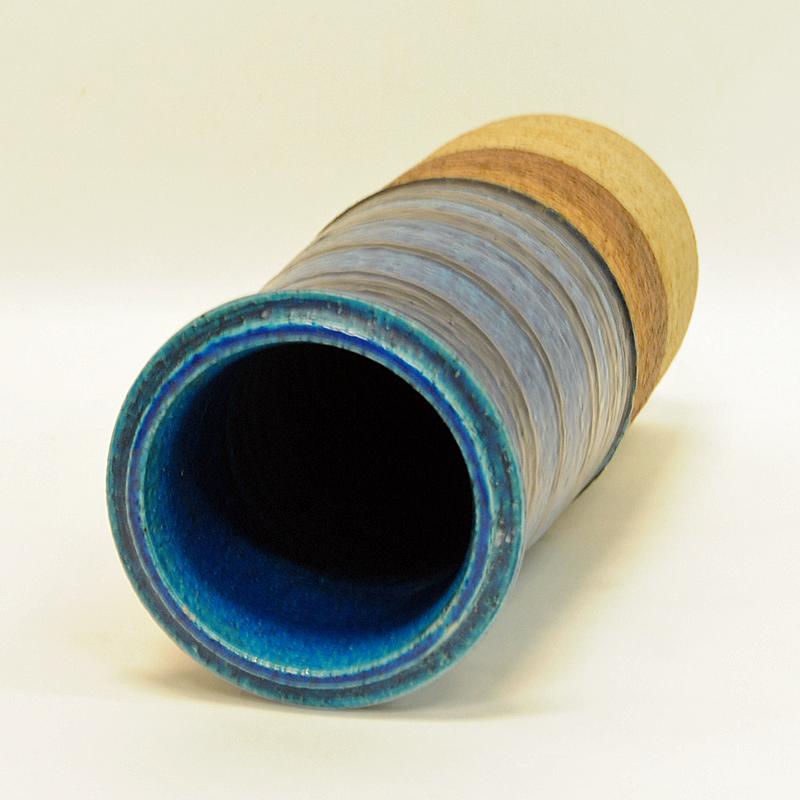 Lovely and colorful stoneware vase partly glazed in brown and blue mix colors. Designed by Inger Persson. Rörstrand, Ateljé Sweden in the 1960s. Glaced smooth blue painted patterns and rougher beige and brown ceramic. Good vintage condition and nice