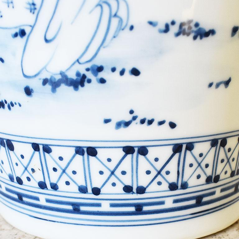 A tall ceramic chinoiserie motif vase. This piece would be wonderful filled with a bouquet of your favorite blooms or grouped with other blue and white vessels. 

Dimensions:
10.5