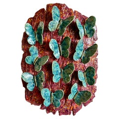 Sculpture murale en céramique avec papillons bleus sur écorce
