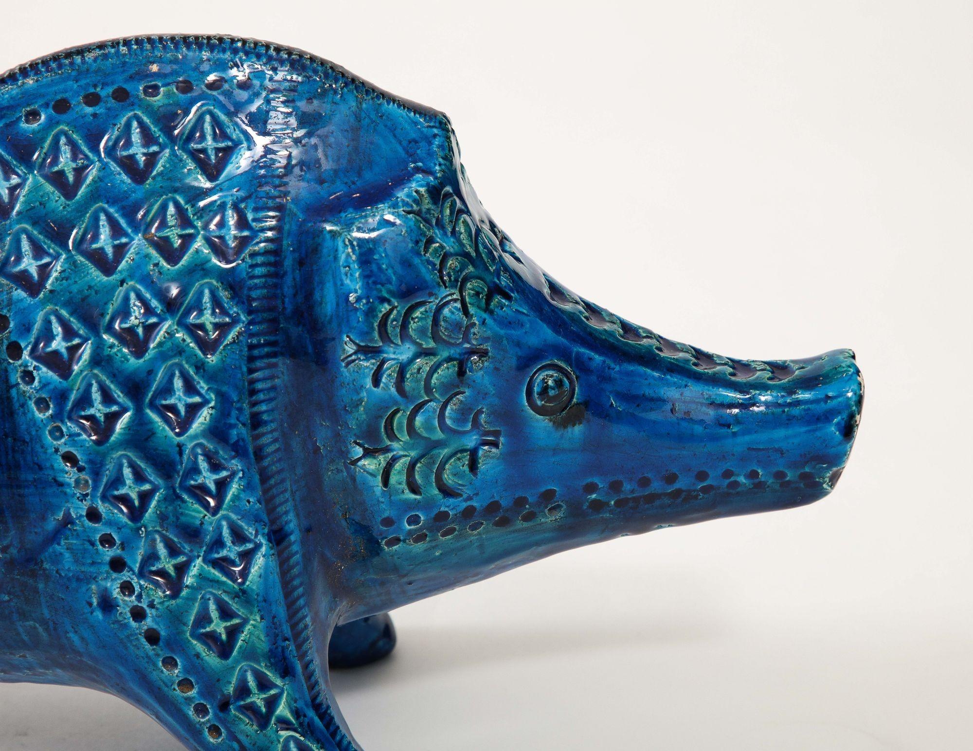 Aldo Londi's Ceramic Boar, created for Bitossi in the enchanting 'Rimini blue' glaze circa 1960, is a stunning representation of Italian ceramic artistry. Crafted with meticulous attention to detail, this boar sculpture embodies the essence of