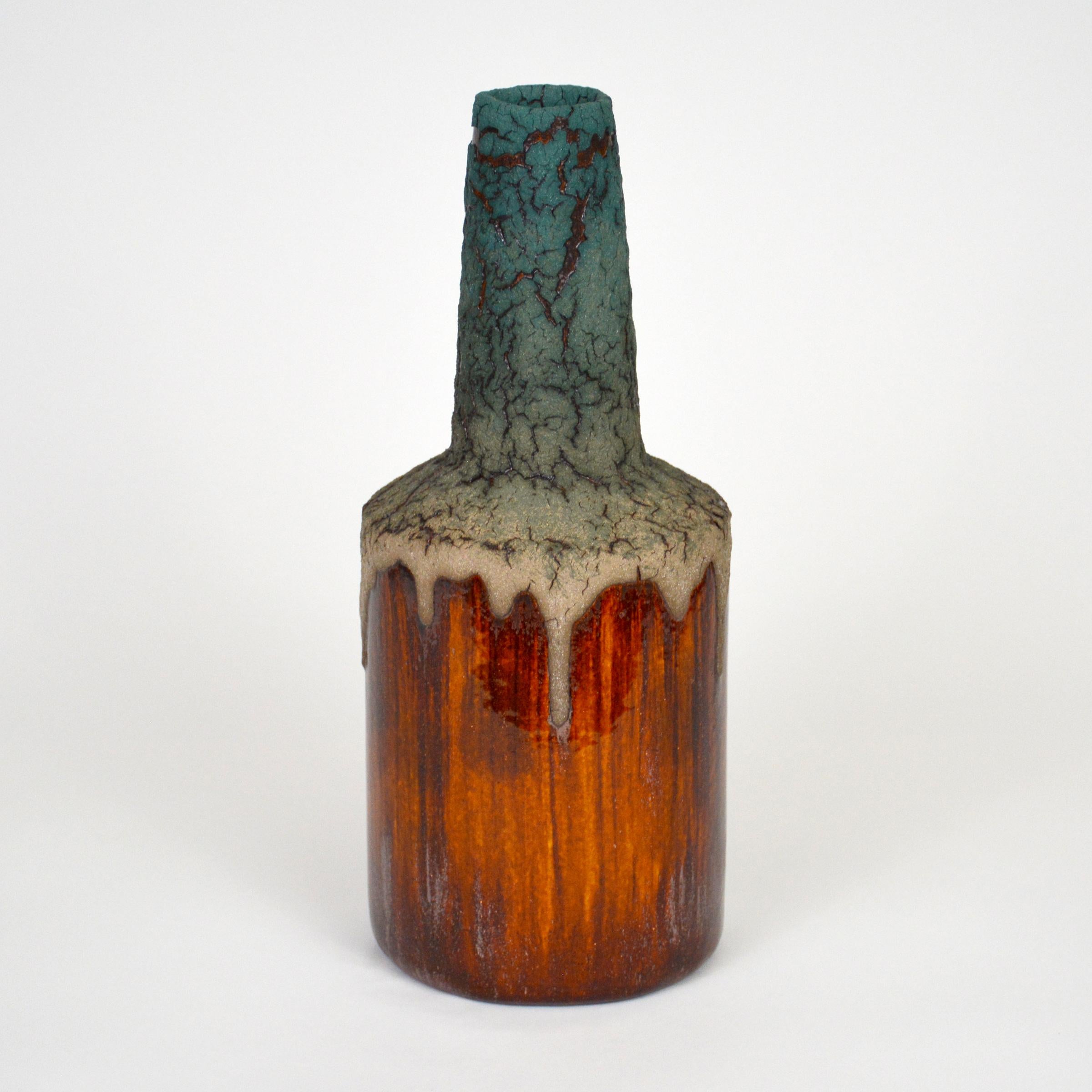 Turquoise Lava Ceramic Bottle by William Edwards
Hand built earthenware vessel, fired multiple times to achieve a textured surface of random abstraction, matte glaze with amber gloss metallic, microcrystalline glaze breaking through that sparkles in