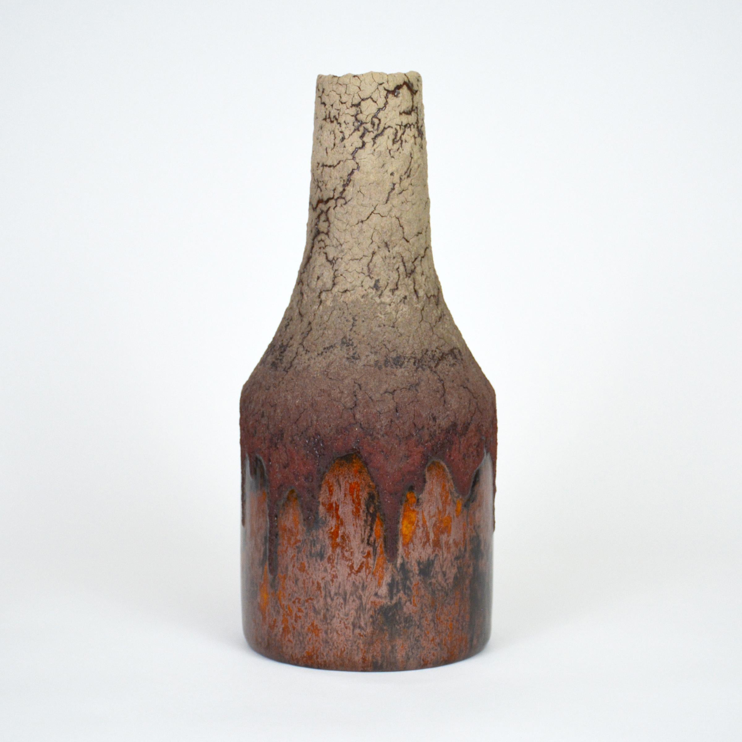 Ceramic bottle by William Edwards
Hand built earthenware decorative bottle, fired multiple times to achieve a textured surface of random abstraction, taupe to burgundy matte with dark amber gloss microcrystalline glaze that sparkles in certain