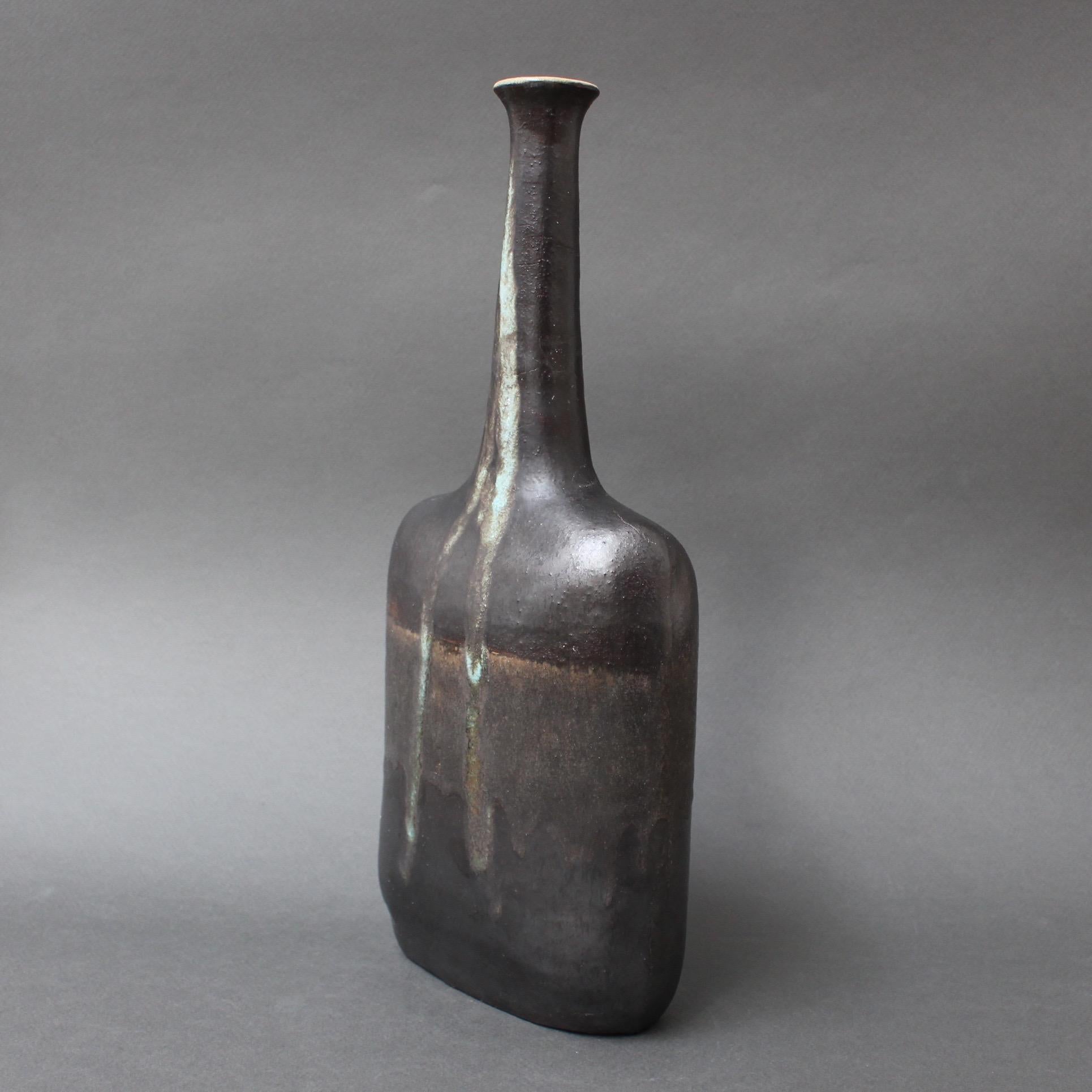 Ceramic vase with flat-black glaze and verdigris drip motif by ceramicist Bruno Gambone, (circa 1980s). This elegant narrow-opening bottle-shaped vase is a work of art. There is a rectangular body with soft, curvy shoulders leading to a graceful,