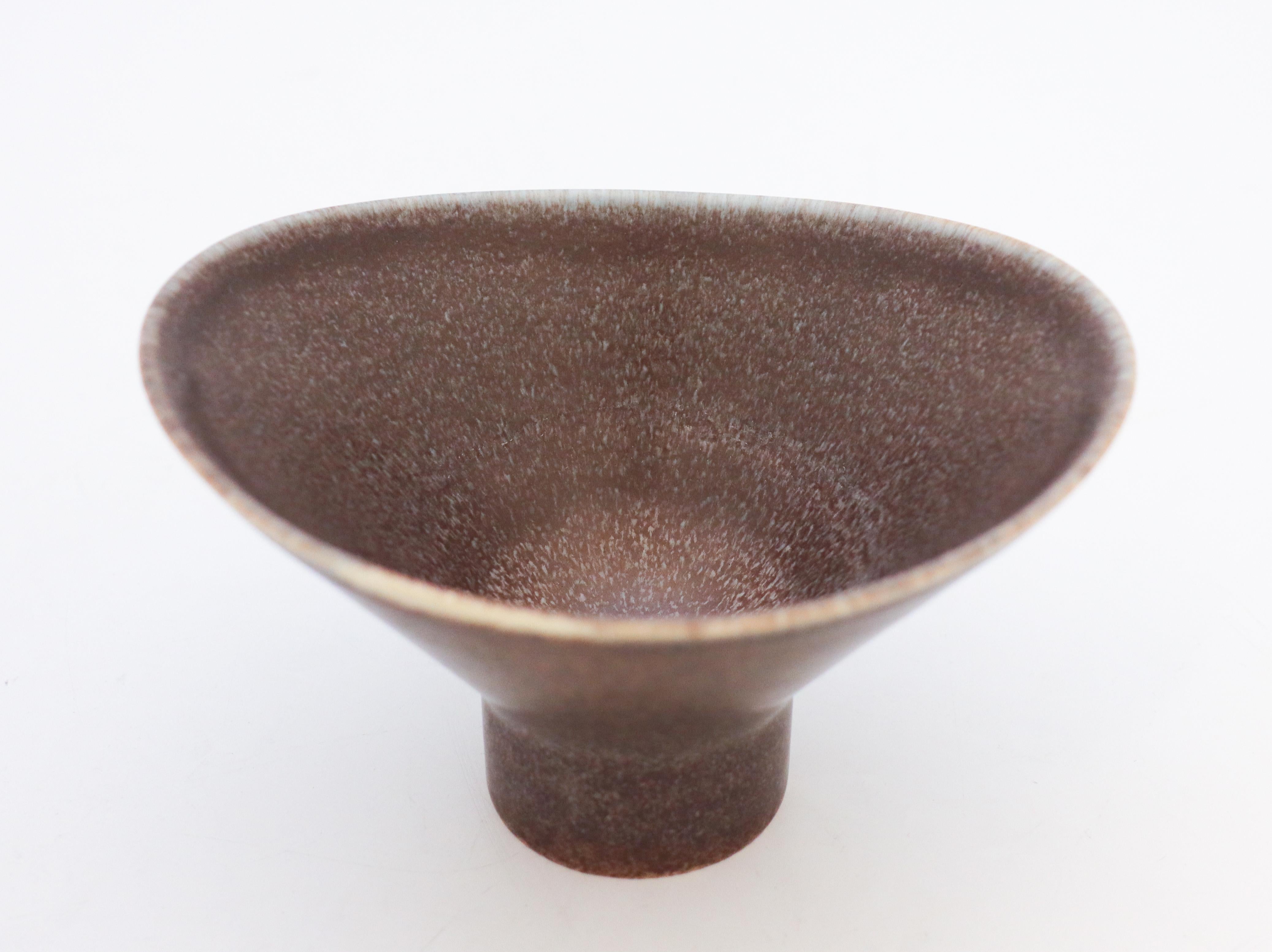 A lovely mid-century bowl in ceramics with a glaze in a purple, brown, blue-toned glaze from Rörstrand, Sweden, designed by Carl-Harry Stålhane. The bowl is marked as 2nd quality and is in excellent condition. 

Carl-Harry Stålhane is one of the