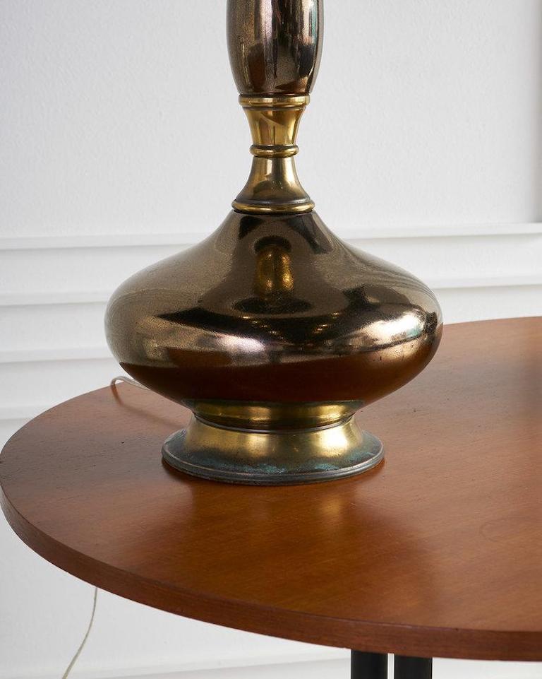 A shapely pair of bronze-colored ceramic and metal table lamps. The gorgeous glaze features a subtle, purposeful crazed finish. Brass hardware accents. Newly wired and ready for use. Lampshades not included, please inquire for availability of