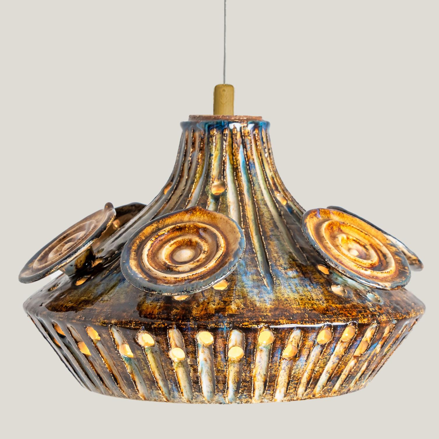 Stunning round hanging lamp with an unusual shape, made with rich grey cognac  brown colored ceramics, manufactured in the 1970s in Denmark. We also have a multitude of unique colored ceramic light sets and arrangements, all available on our
