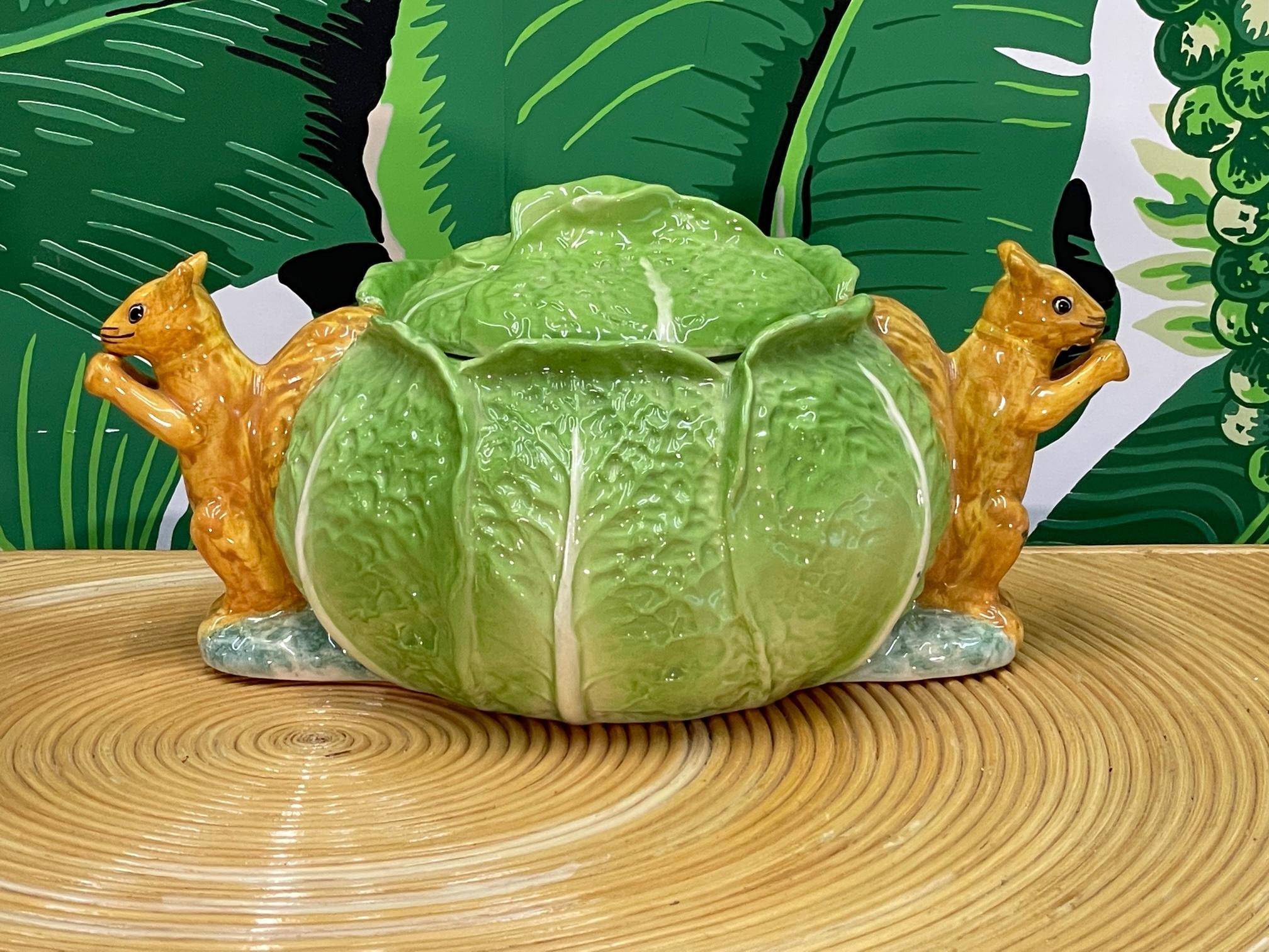 A ceramic cabbage head cookie jar with lid by Gloria Vanderbilt features cute squirrels adorning each side. Good condition with no cracks or chips.

