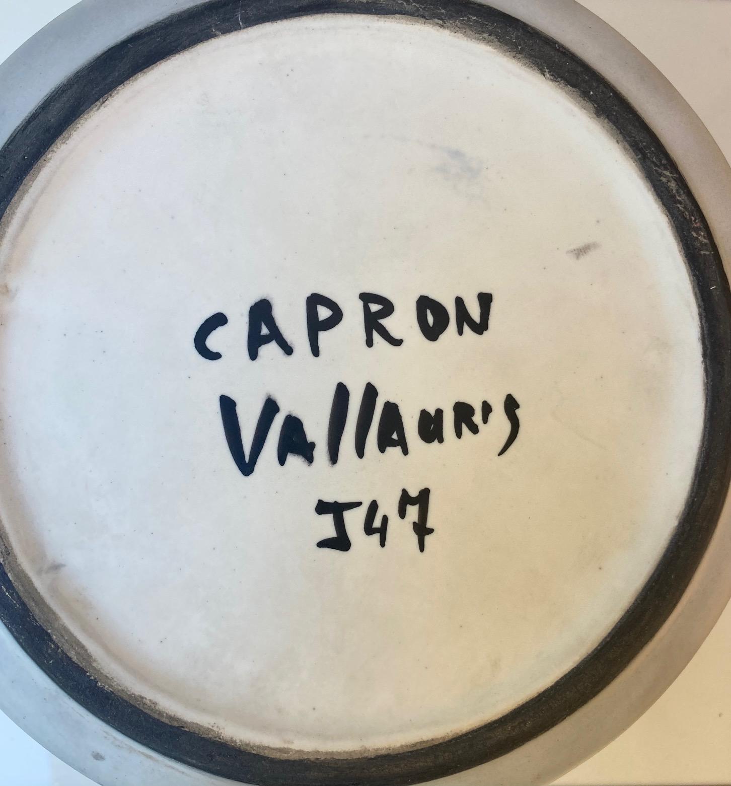 A cylindrical vase, cachepot or wine cooler,
White glazed ceramic with striped polychrome decoration.
Stamped underneath: Capron Vallauris J 47
Vallauris, France, circa 1960.

Measures : 
Height 19 cm 
Diameter 20 cm (in.).