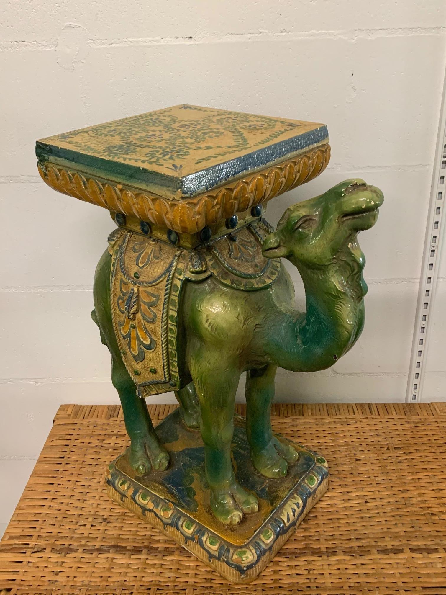 Vintage camel garden stool/seat/footstool features hand painted finish and adds a perfect amount of whimsy to any decor. Good condition with no structural issues but some small imperfections to paint. Measures: Stands 22.5