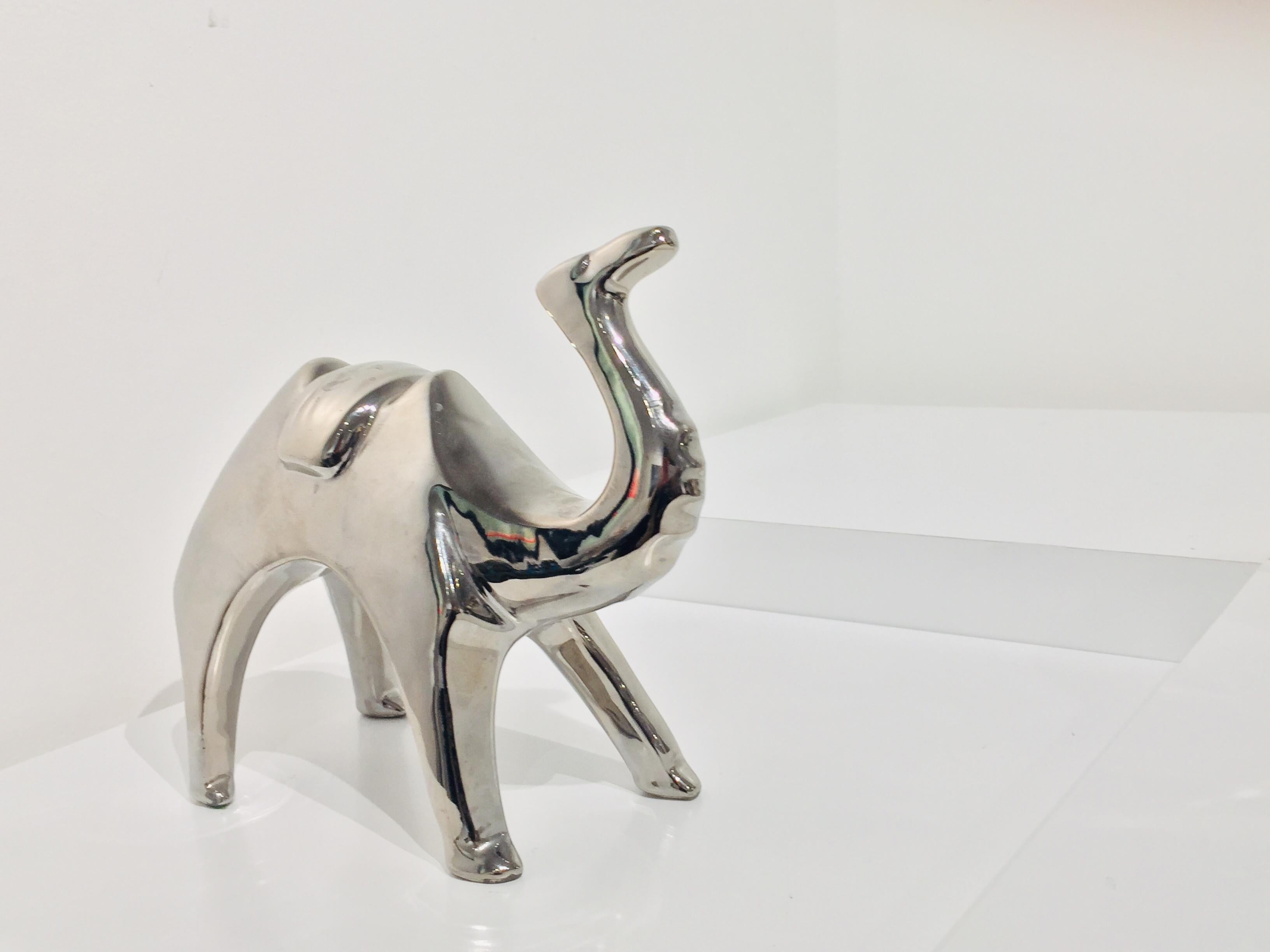 Contemporary ceramic camel with mirror finish. Color varies depending on the light and objects around it.
