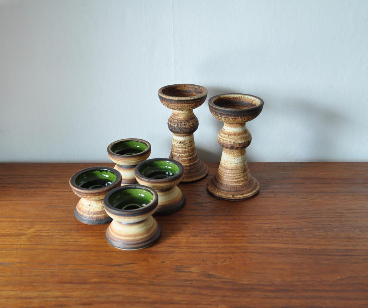 Set of six ceramic candlesticks by Brigitte Andrzejak, who had a studio on the island of Møn (Moen) in southern Denmark. No longer active. These pieces appear to be from the late 1970s or early 1980s going by the glaze and the oxide banding around