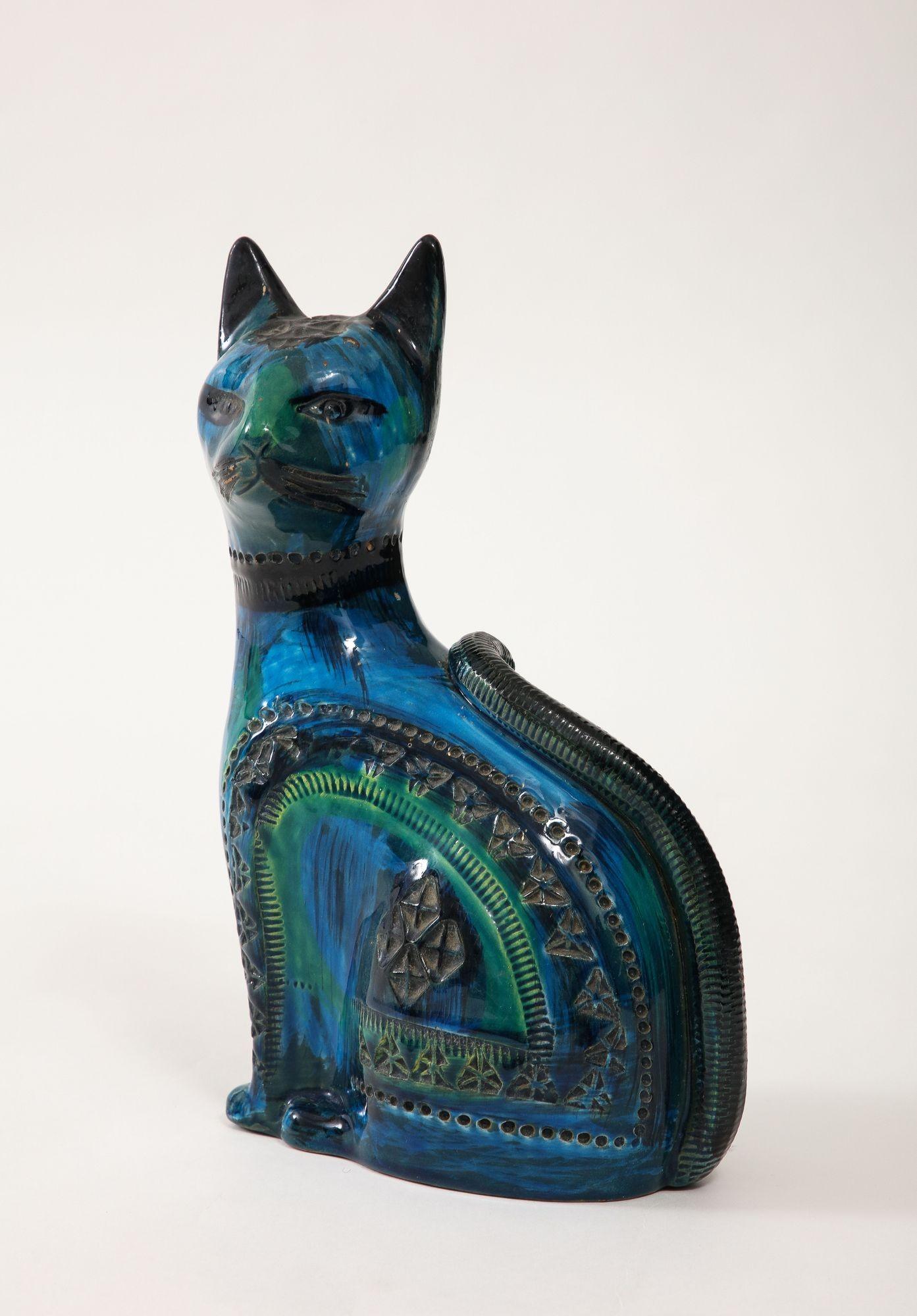 Aldo Londi's Ceramic Cat for Bitossi, crafted in the iconic 'Rimini blue' glaze circa 1960, is a masterpiece of Italian ceramic artistry. Standing as a testament to Londi's creative genius, this feline sculpture boasts a sleek and stylized form,
