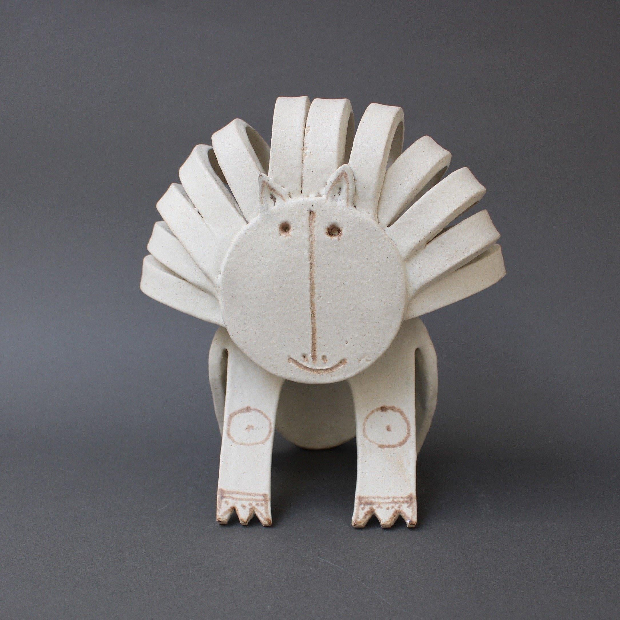 Ceramic cat or lion sculpture by ceramicist Bruno Gambone (circa 1970s). This enchanting cat is a delightful work of art. It is whimsical, yet beautiful in its use of the pared-down design elements associated with minimalism. Its chalk-white colour
