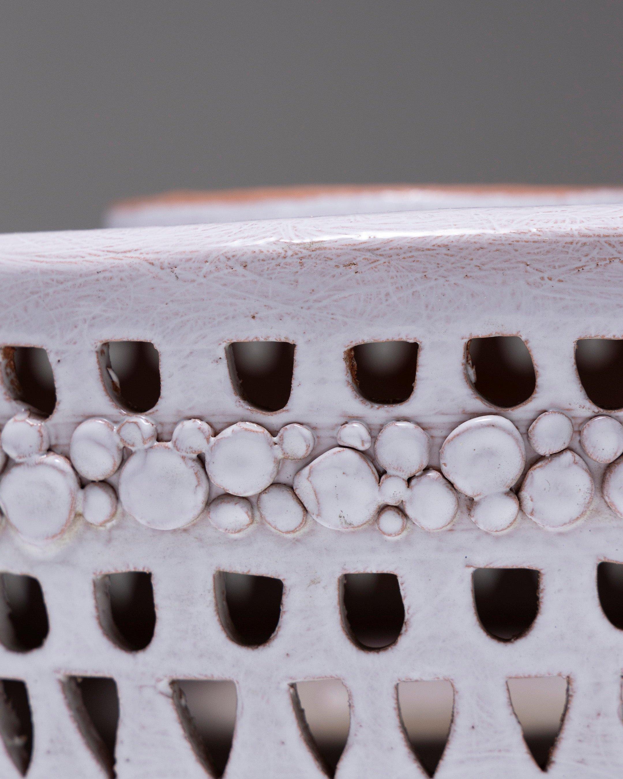 Grande ciotola centrotavola in ceramica bianca di Fred & Andrée Stocker degli anni '60. Il bordo è forato e ornato da eleganti motivi scolpiti. In ottime condizioni.
DV1358
