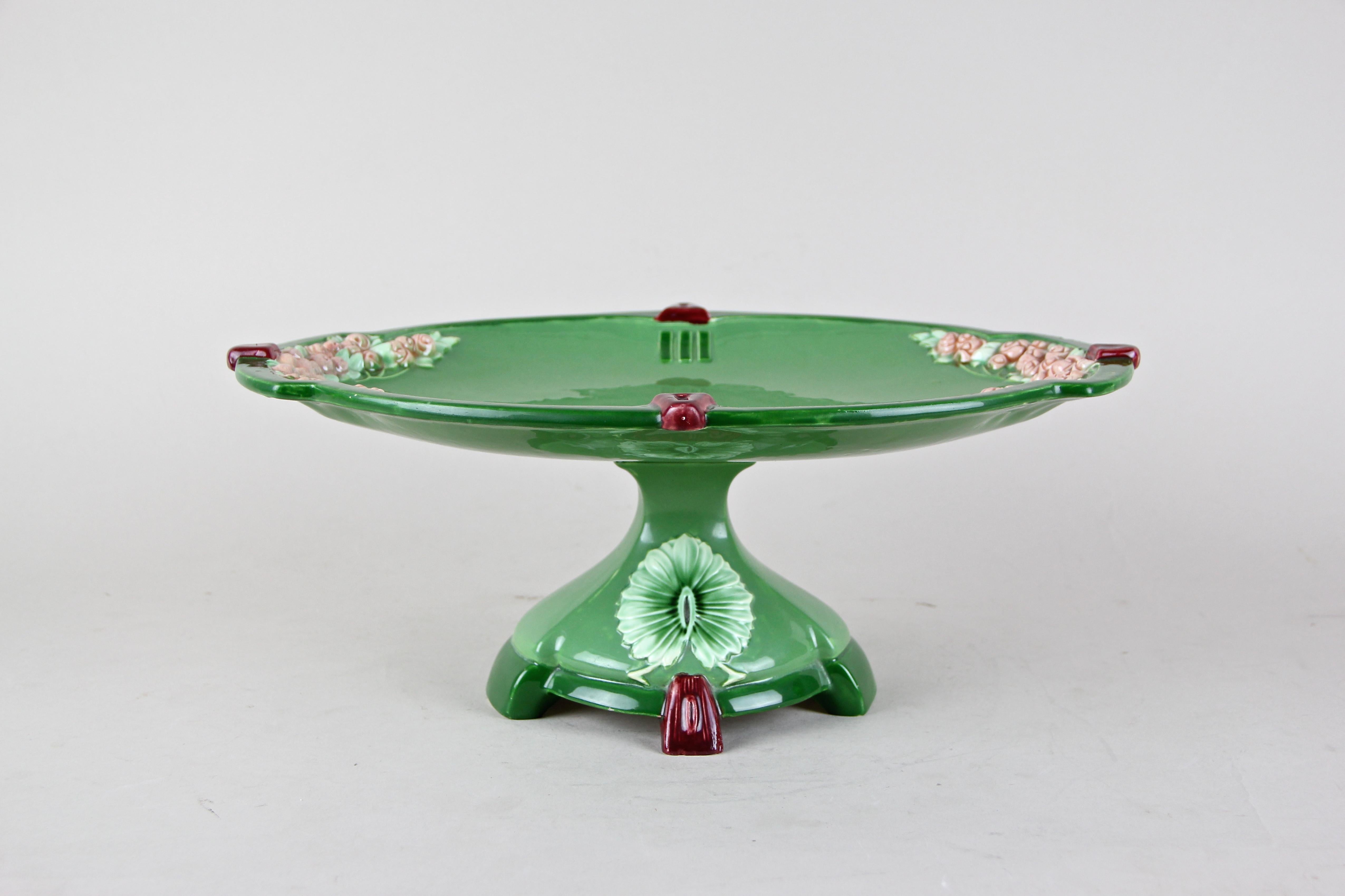 Beautiful ceramic centrepiece by the renown Majolica manufactory Eichwald, circa 1910. Famous for their unique style and design this oval centrepiece sits on a great shaped base with two white blossoms and red accents. The wonderful composed