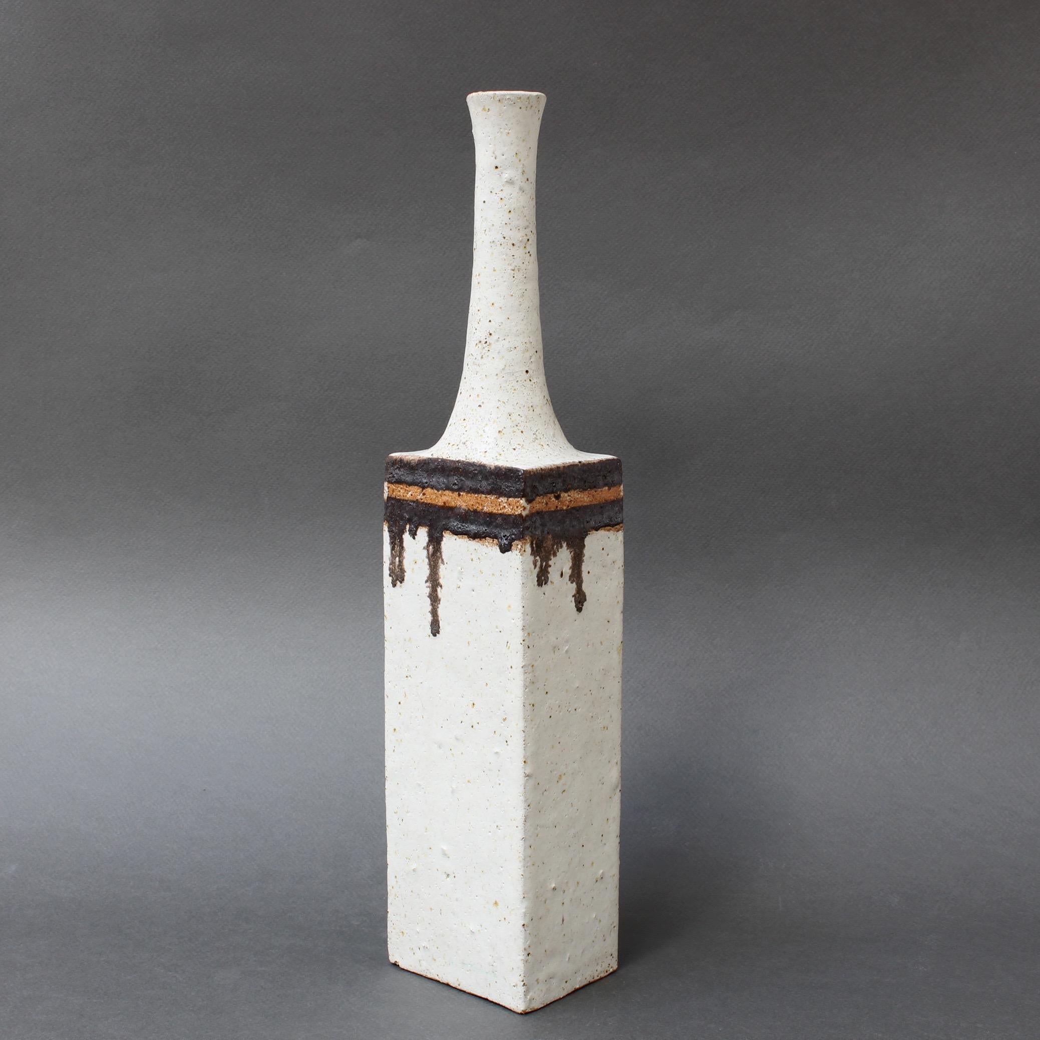 Ceramic decorative vase with chalk-white surface and chocolate-brown drip motif on the top of the rectangular body, by ceramicist Bruno Gambone, (circa 1970s). This graceful narrow-opening decorative vase is a work of art. With a modern rectangular