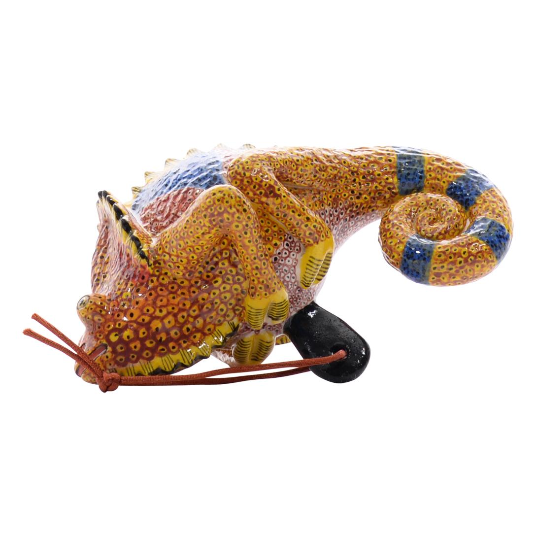 Bring the spirit of Africa into your holiday décor with Love Art Ceramic's Chameleon ornament. Hand-crafted by Nozipho Ntshalintshali and Sondelani Ntshalintshali, this 4-inch tall, 2-inch long, and 2-inch wide ceramic piece captures the playful