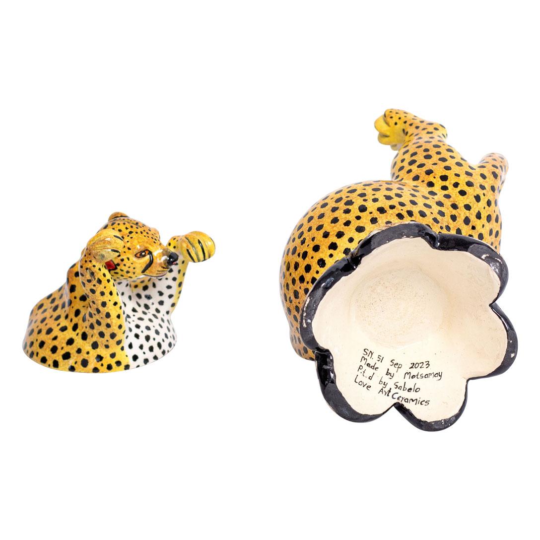 This ceramic Cheetah jewelry box, crafted by Sabelo Nene at Love Art Ceramic studio in South Africa, intertwines African wildlife with artistry. Standing 6 inches high, 4 inches long, and 5 inches wide, its design captures the essence of the
