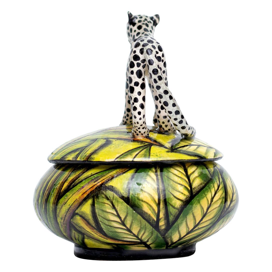 Discover the elegance of African artistry with this enchanting ceramic Cheetah jewelry box, meticulously crafted by the talented Samukelo Gumede and Bennet Zondo at Imvelo Natural Art in South Africa. Standing 5 inches high, 4 inches in length, and