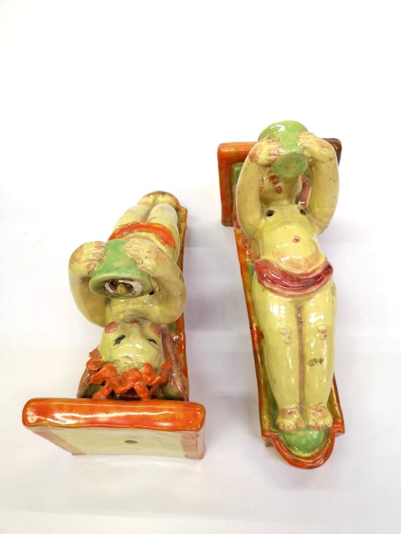 This pair of handmade ceramic cherub wall shelves were made in the 1930s. It's possible to add electric sockets to the planters the angels are holding-though originally they carried candles. The ceramic is originally drilled, so it can be changed to