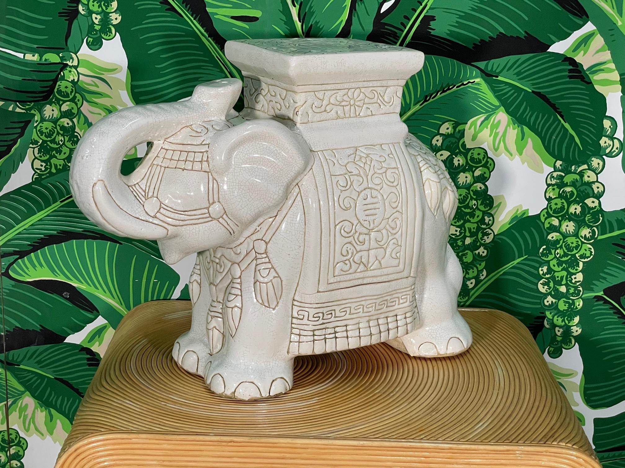 Ceramic elephant garden seat (or end table for cocktails) features a bright, glazed finish and a raised trunk signifying good luck. Good condition with imperfections consistent with age, see photos for condition details. 
For a shipping quote to