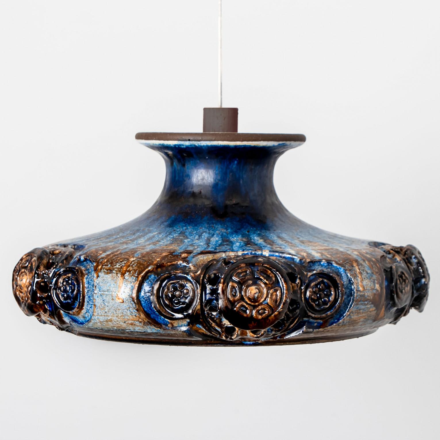 Stunning round hanging lamp with an unusual shape, made with rich cobalt colored blue ceramics, manufactured in the 1970s in Denmark. We also have a multitude of unique colored ceramic light sets and arrangements, all available on the website. All