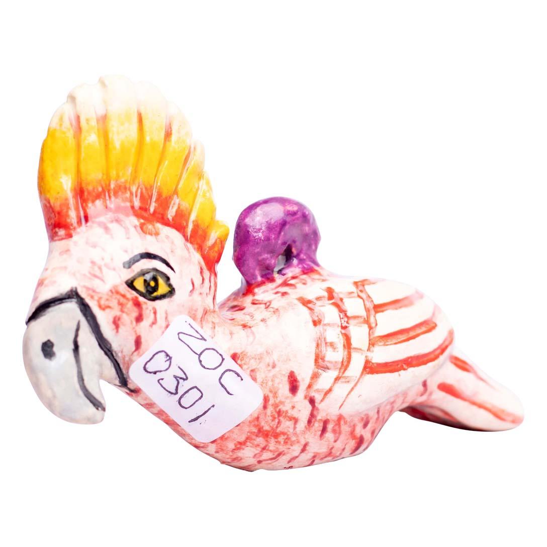 The ceramic Cockatoo ornament from Zimele Ceramics, South Africa, showcases the artistry of Lindy, who both hand-sculpts and paints each piece. This unique ornament is compact, measuring 2 inches high, 4 inches in length, and 1 inch in width, yet it