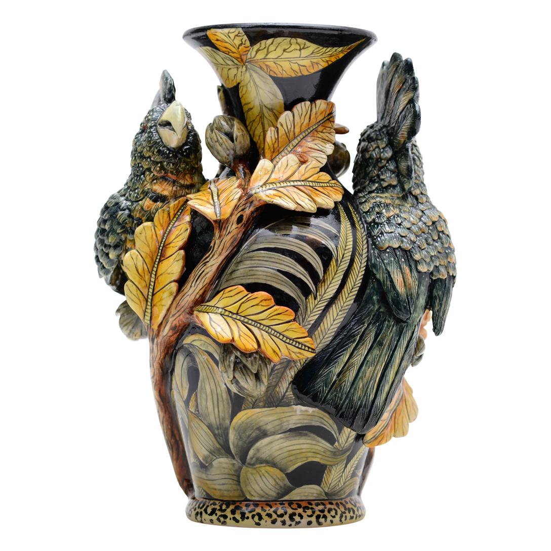 The Cockatoo Vase by Senzo Duma Ceramic Arts, sculpted by Thabo Mbhele and hand-painted by Senzo Duma in South Africa, stands 12 inches high, 8 inches long, and 6 inches wide. The cockatoo, though not native to Africa, embodies themes of exotic