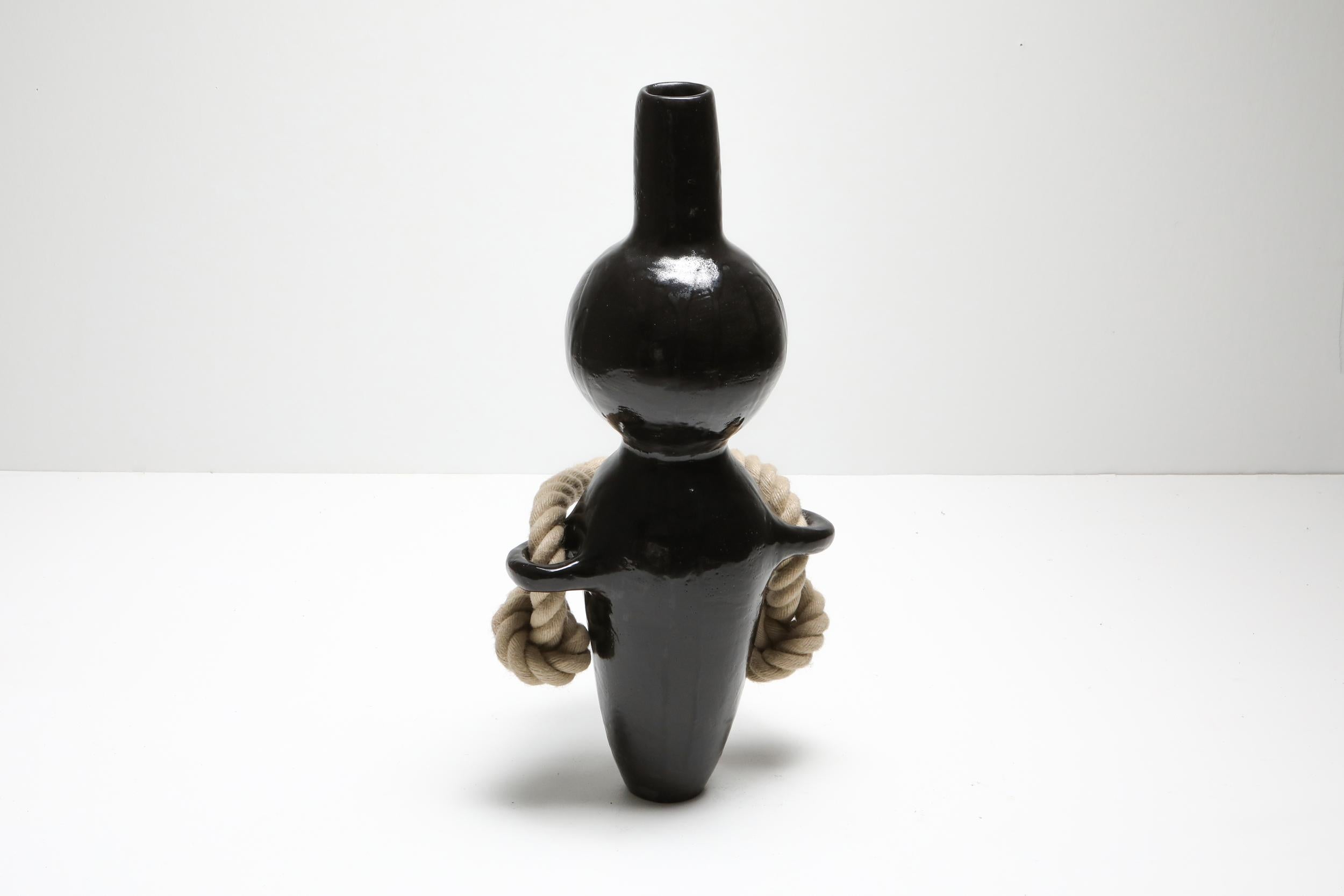 Black Sculptural ceramic vessel with thick rope, Harvey Bouterse, made in Belgium, 2018. 
The sculpture shows beautiful textures in combination with elegant color display in diverse brown tone glazing.