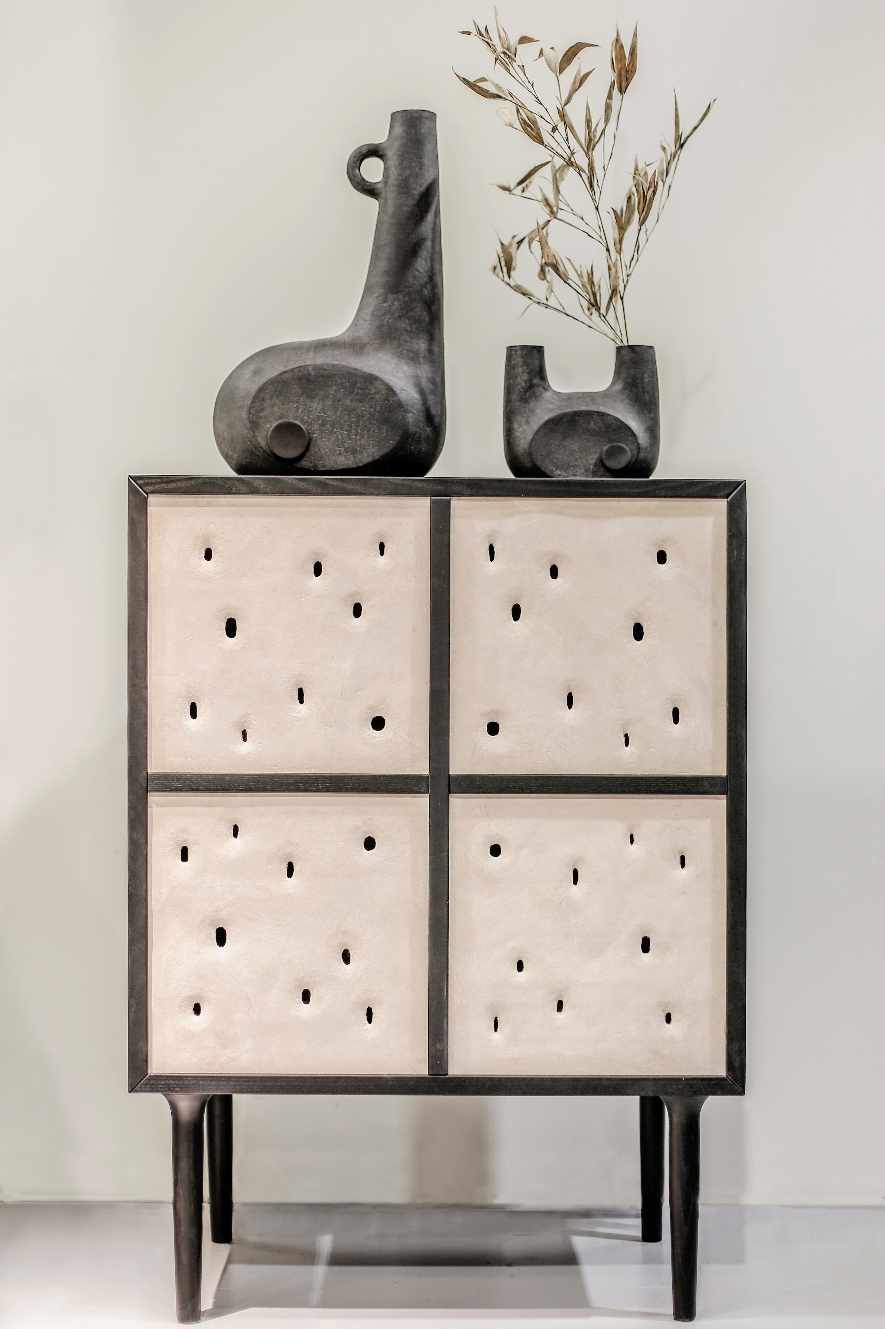 Ceramic contemporary bar cabinet by FAINA
Design: Victoriya Yakusha
Material: clay, ash
Dimensions: 76 x 44.3 x H 106 cm

Made in the style of ethnic minimalism, the collection items introduce “naive design”- simple in form, yet with a deep