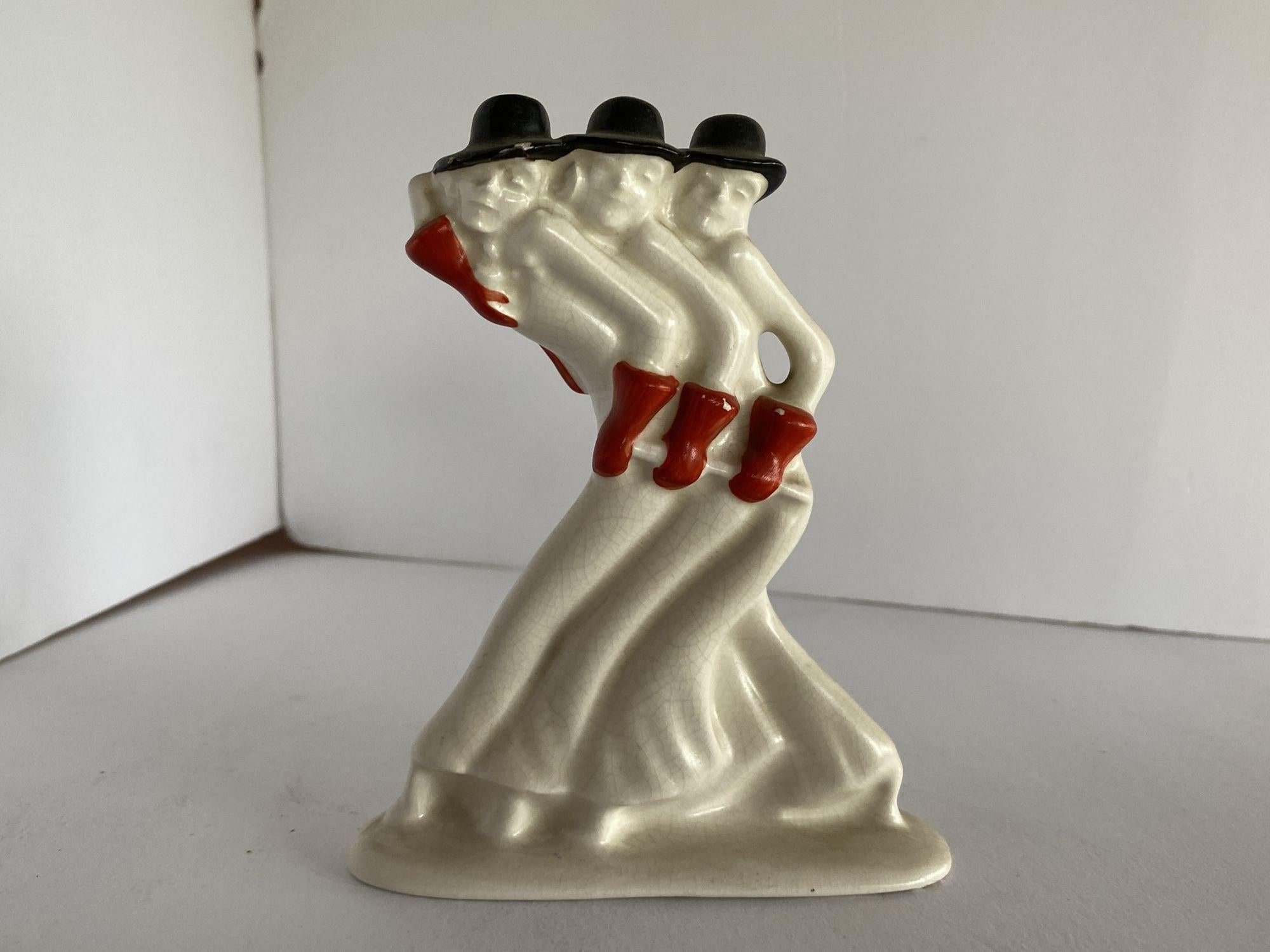 Art Deco colored ceramic dancing showgirl pair, by Etha Lempke for Plateelbakkerij Zuid-Holland Gouda, featuring one solid colored statue and one two-tone statue. 
 
Circa 1930.