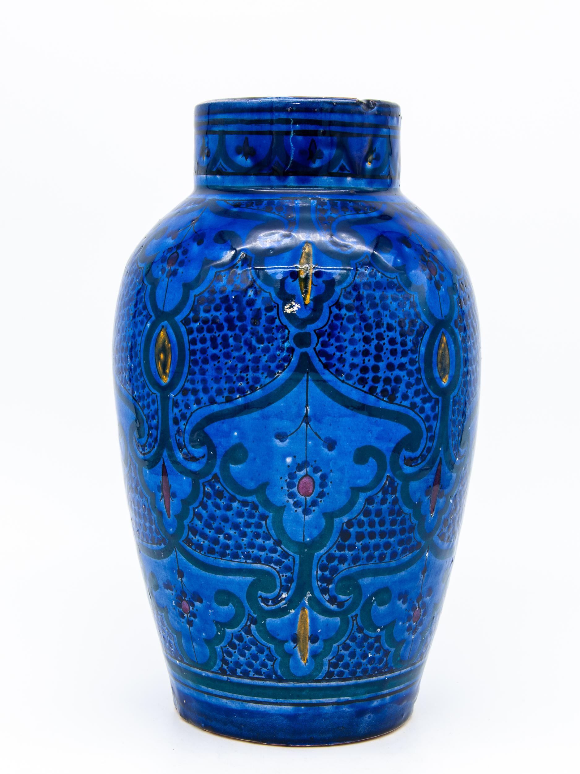 Mid 20th century vase in the Moorish style. Cobalt blue in color with peaks of red and orange. Wear consistent with age and use.