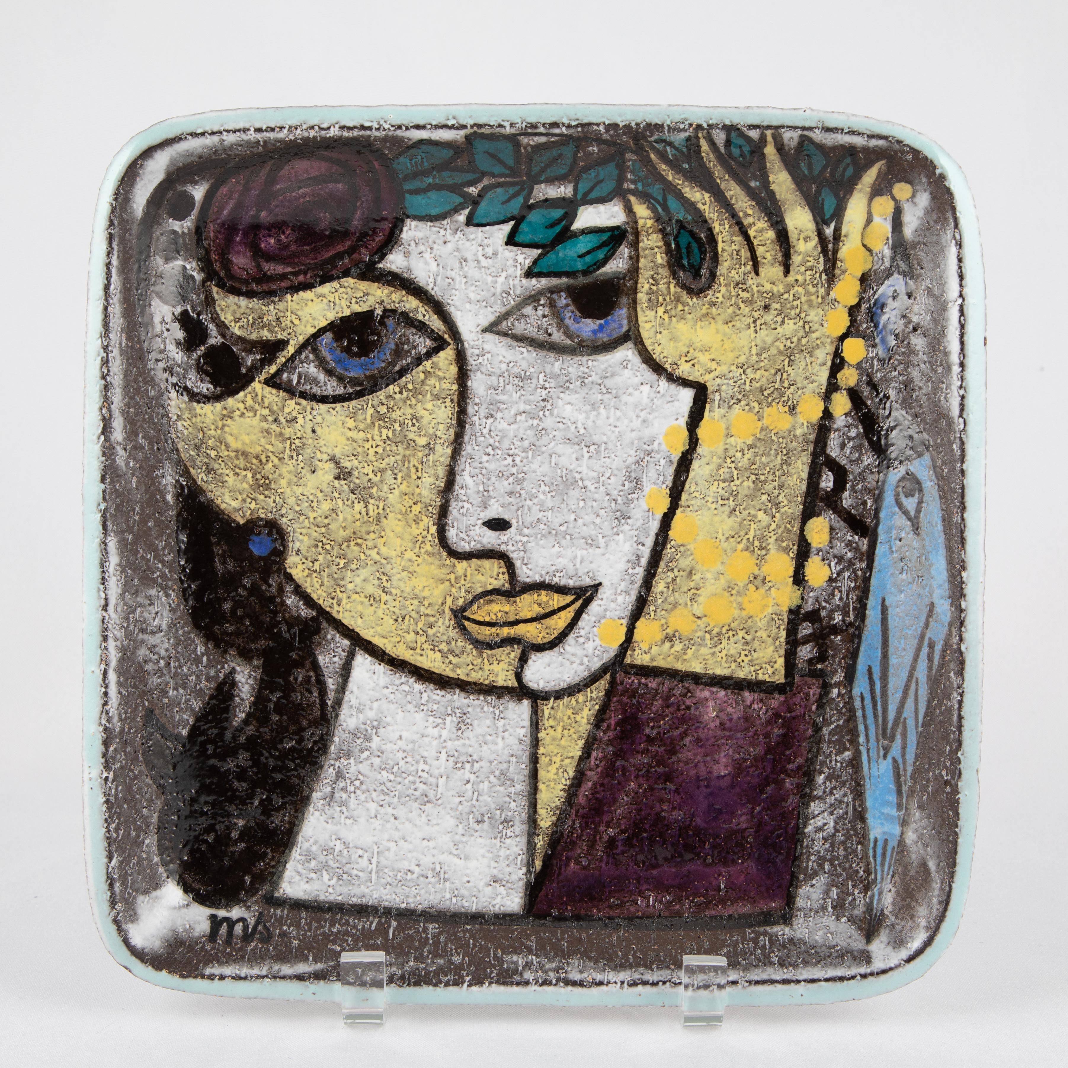 Square dish by Swedish ceramicist Mari Simmulson (1911-2000) for Upsala Ekeby features a stylized, Picassoesque portrait of a woman and a bird. 