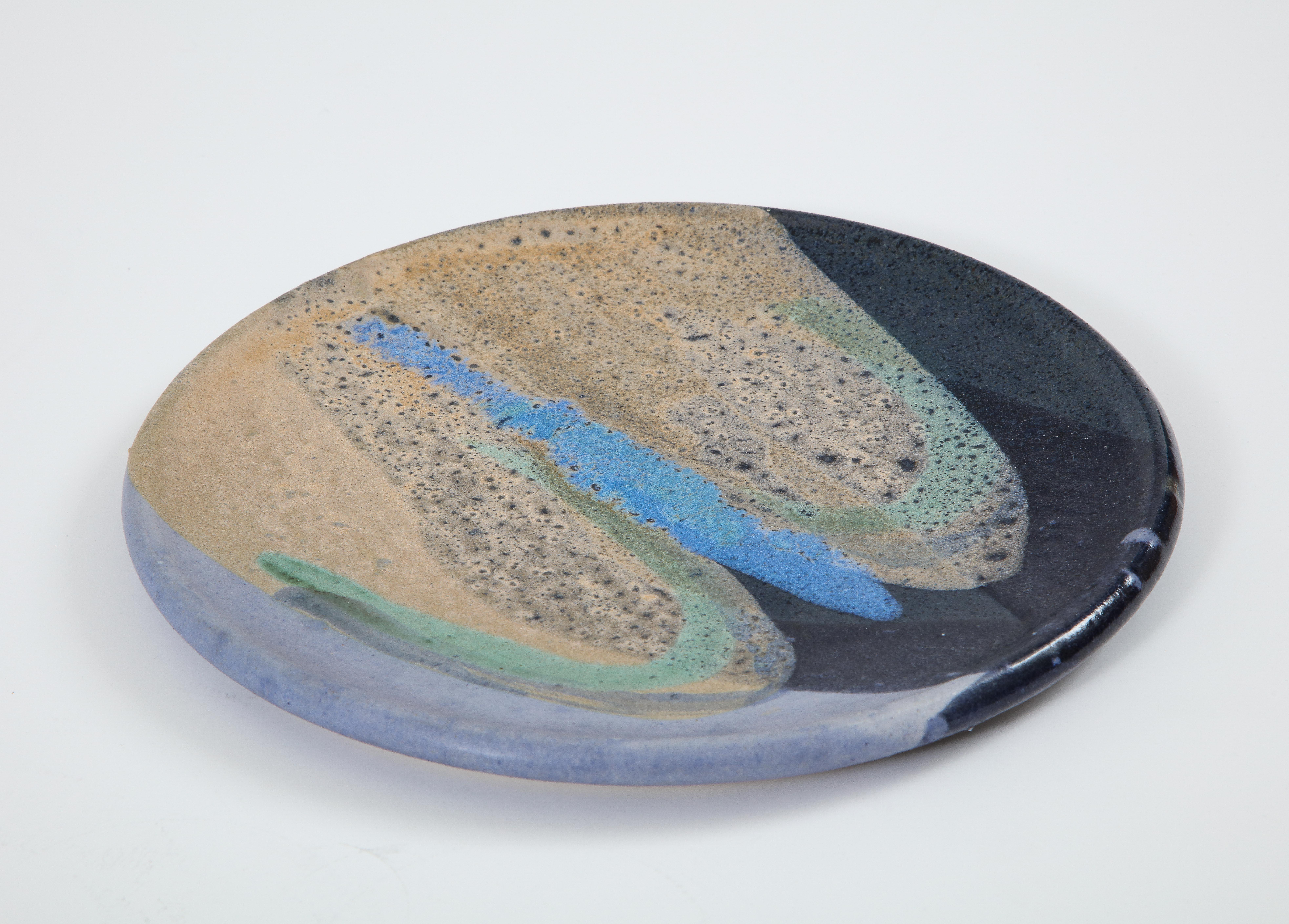 Ceramic plate with abstract enamel glaze, signed 'Helwig'.