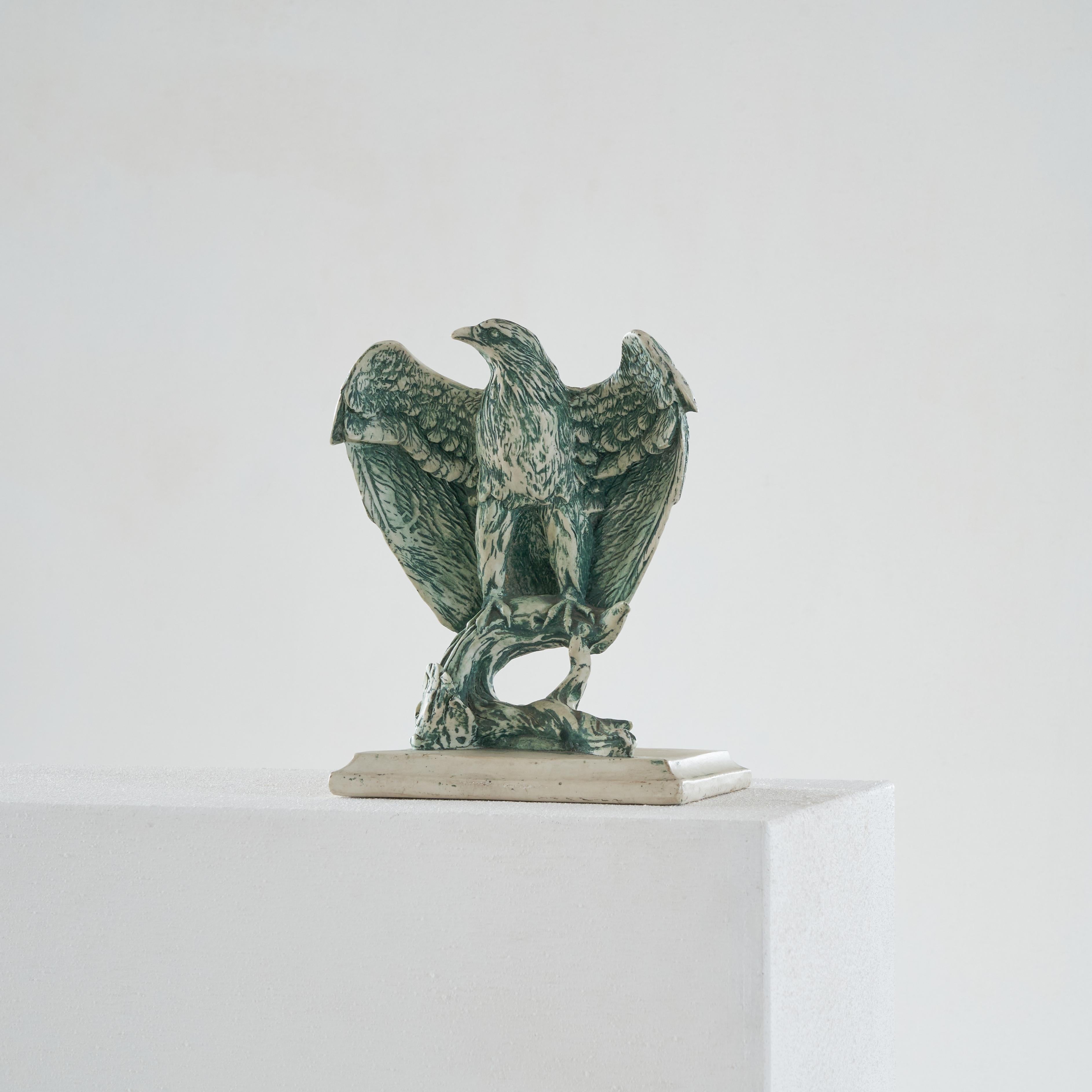 Ceramic Eagle Sculpture, 20th century. 

Wonderful and beautifully made sculpture of an eagle. Well made, great proportions and nice details like the green glaze and the delicate feathers. 

It depicts an eagle sitting on a branch and spreading