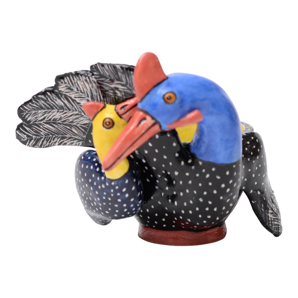 The ceramic Guinea Fowl Egg Cup, crafted by Sbusiso and hand-painted by Sabelo at Love Art Ceramic in South Africa, embodies the essence of African wildlife. Measuring 2 inches high, 4 inches in length, and 2 inches in width, it features a mother