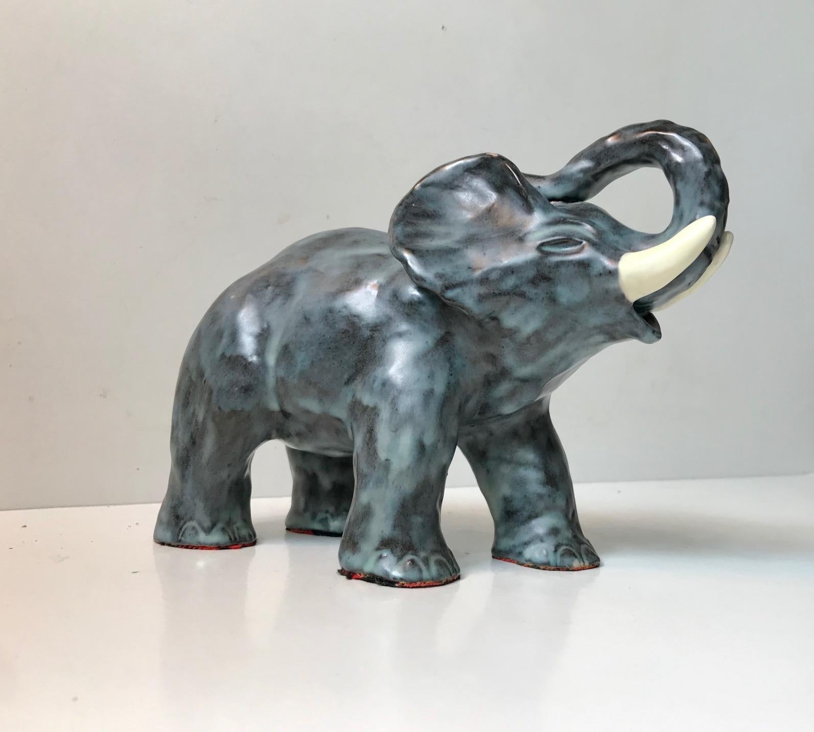 Michael Andersen elephant executed in polychrome glazed ceramic. Very rare version with blue and black glaze. It is imprinted with the crest mark and design number to the front feet. It has a height of 15 cm and a length of 22 cm.