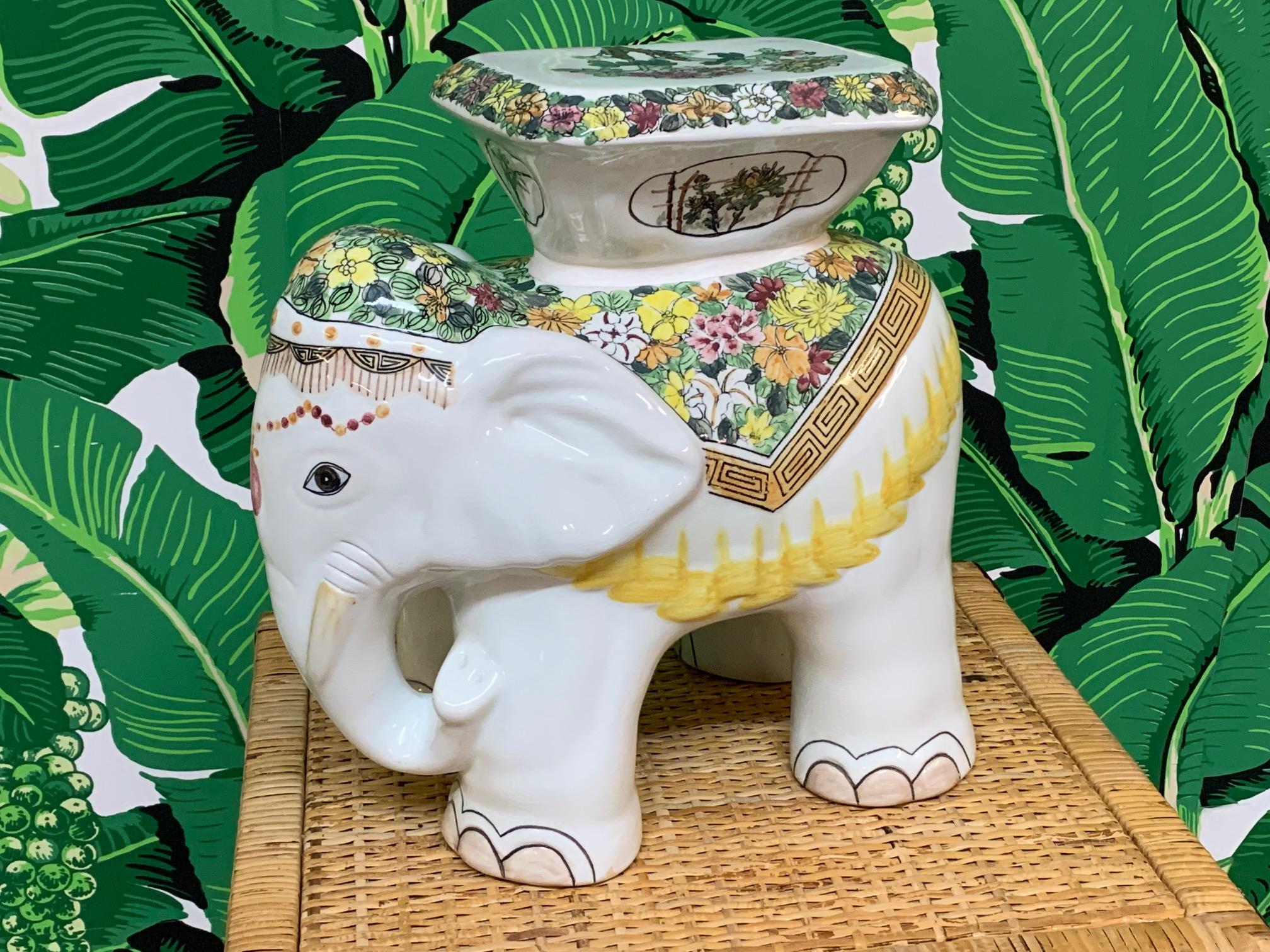 Cute ceramic elephant garden stool, could be used as an end table, finished in glossy white with vibrant flowers. Excellent condition overall.  A9456