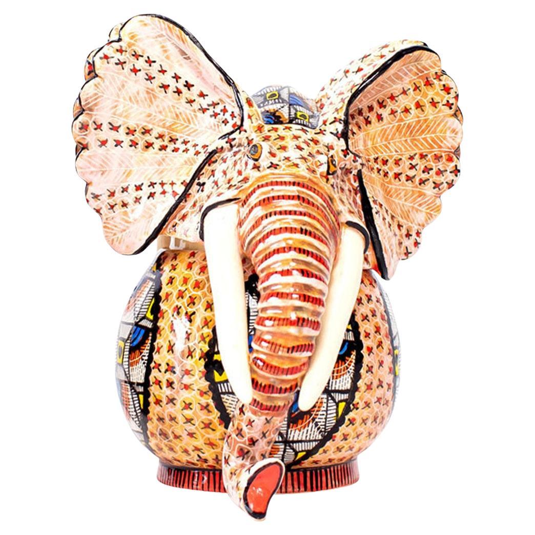 This ceramic Elephant head jewelry box is a stunning embodiment of African culture. Handcrafted by Jabu and sculpted by Sbusiso Ndaba at Love Art Ceramic studio, it measures 5 inches high, 5 inches long, and 4 inches wide. The intricate Zulu pattern