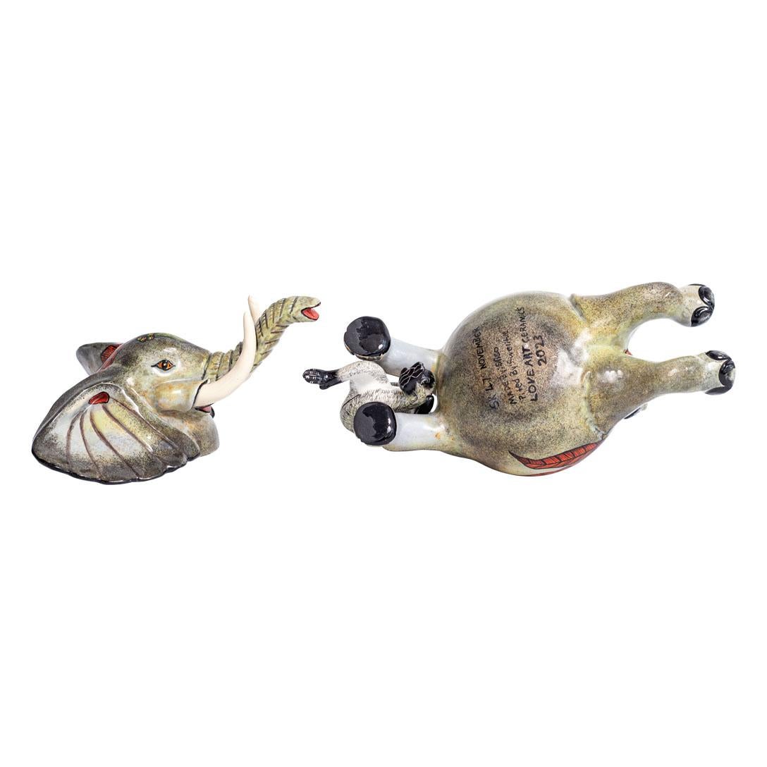 The ceramic Elephant jewelry box, crafted by Swelihle Khanyeza and hand-sculpted by an unnamed artisan at Love Art Ceramic in South Africa, stands as a testament to African artistry. Measuring 6 inches in height, 8 inches in length, and 4 inches in