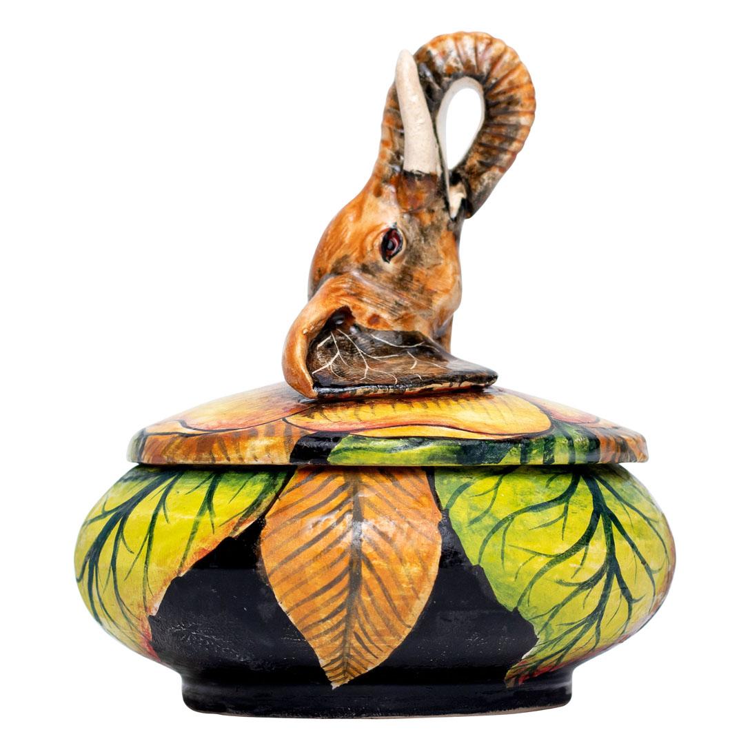 Introducing a captivating ceramic jewelry box, an exquisite fusion of artistry and cultural heritage, handcrafted by renowned South African artisans. This unique piece, standing 5 inches high, 4 inches long, and 4 inches wide, showcases the combined