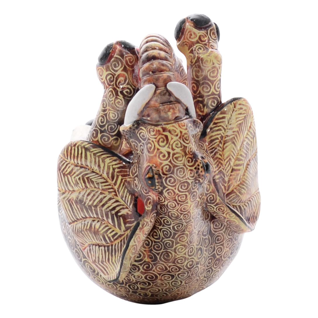 Crafted by the skilled hands of Nozipho Ntshalintshali and sculpted by Sondelani Ntshalintshali, this ceramic Elephant ornament from Love Art Ceramic Studio in South Africa stands as a testament to African artistry. Standing 4 inches tall, 2 inches