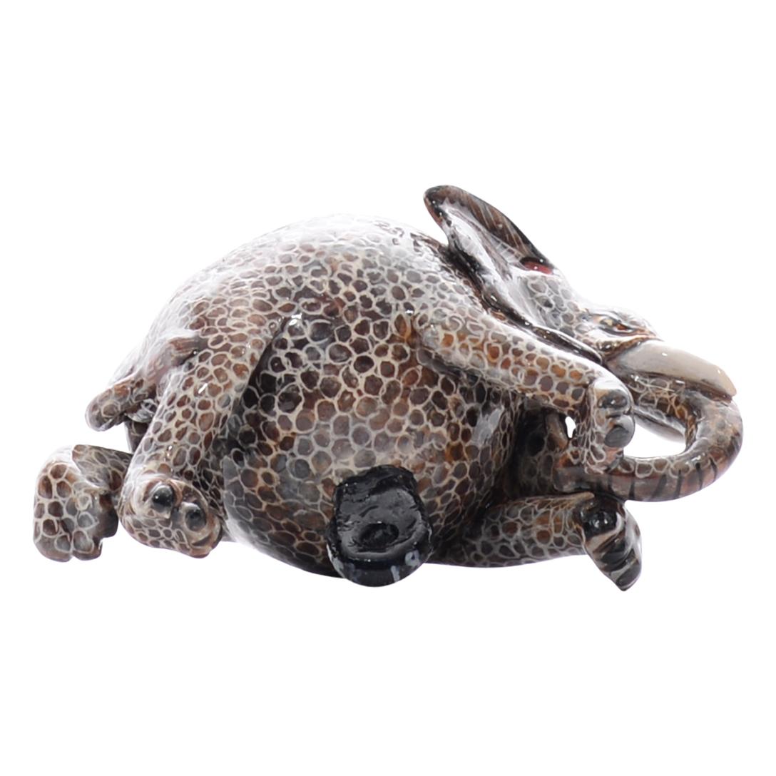 Hand-painted by Nozipho Ntshalintshali and hand-sculpted by Sondelani Ntshalintshali at Love Art Ceramic Studio in South Africa, this ceramic Elephant ornament captures the essence of African wildlife. Measuring 2 inches tall, 3 inches long, and 2