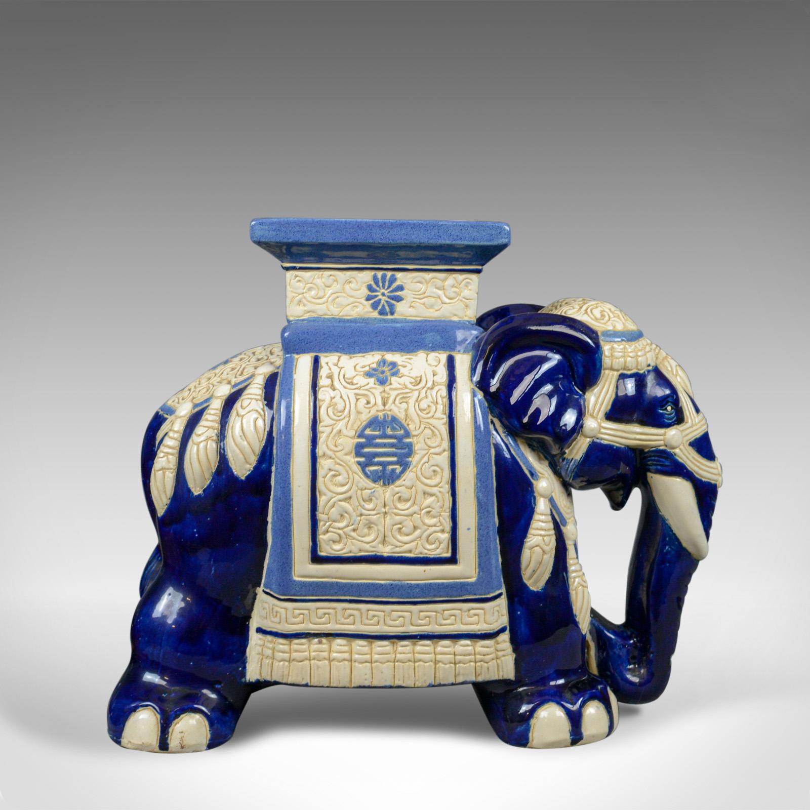 This is a ceramic elephant plant stand or garden companion table dating to the mid-late 20th century.

A large piece offering a stabile platform at 44 cm (17.25