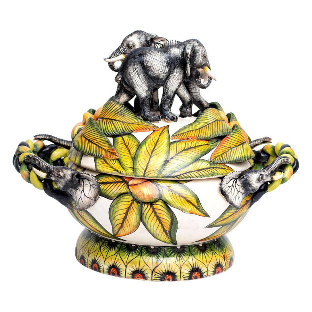 Imvelo Natural Art presents a remarkable ceramic Elephant sweet dish from South Africa. Hand-sculpted by Bennet Zondo and hand-painted by Elvis, this piece stands 17 inches high, 13 inches long, and 13 inches wide. The dish is adorned with intricate