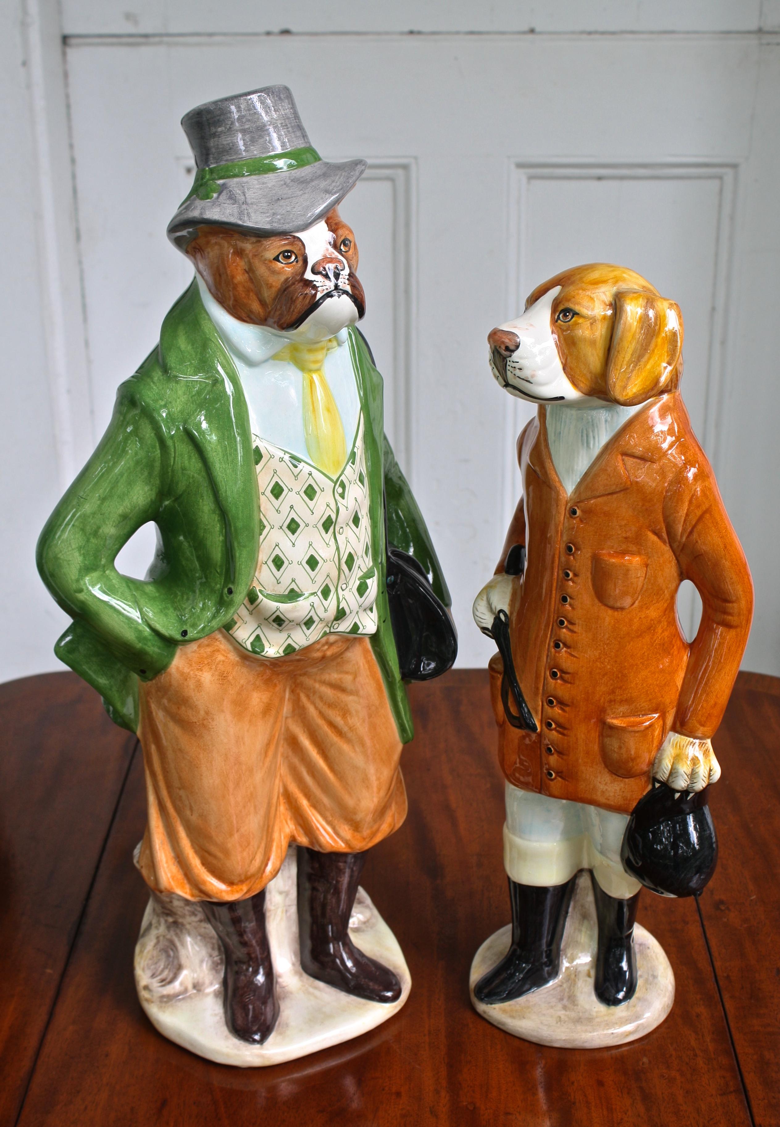 Two Italian ceramic dogs; dressed as an equestrian couple from the late 19th century.
The shorter, appearing to be a foxhound 'whipper-in': 20 1/4 inches tall by 8 inch diameter;
bearing the mark 