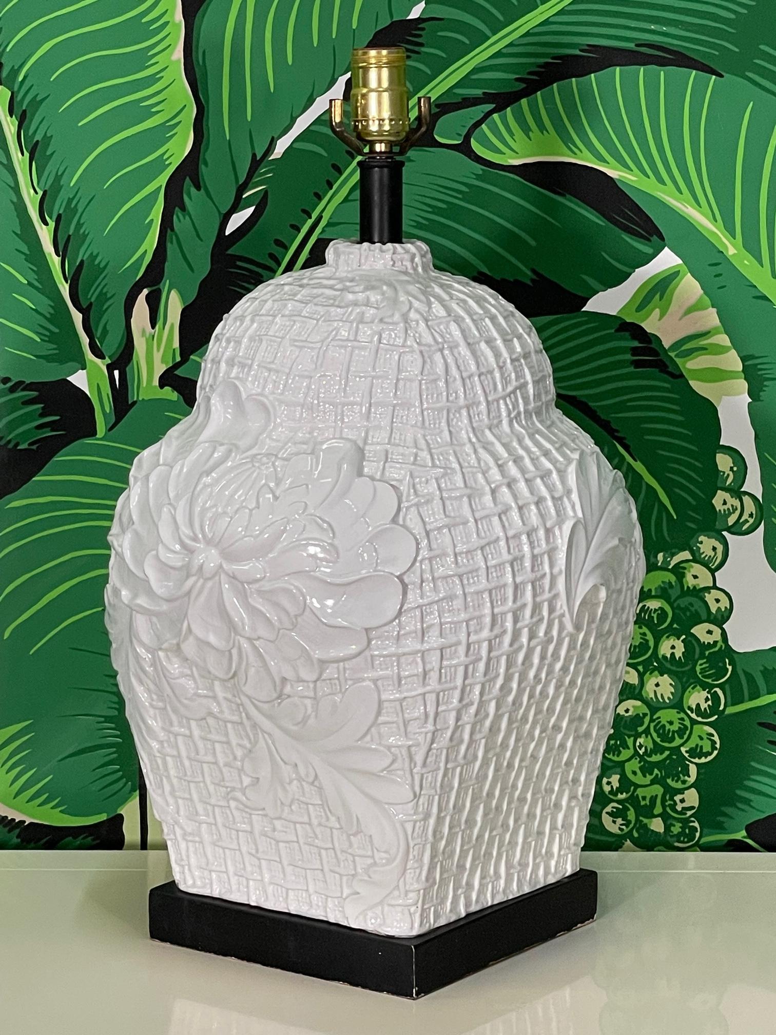 Ceramic ginger jar style table lamp features a faux wicker and floral relief of acanthus leaves and blooms. Sits on metal plinth. Good condition with only minor imperfections consistent with age, see photos for condition details.
For a shipping