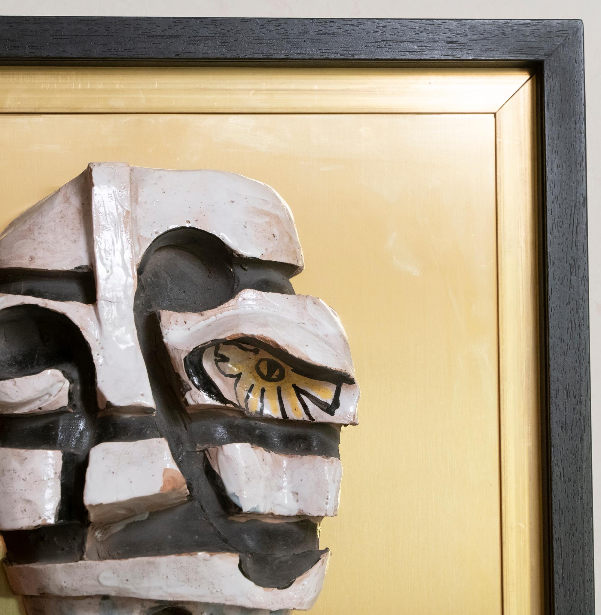 Cubism style figurative glazed terracotta wall art on natural brass structure and framed in black wood, unknown artist, Italy, circa 1970s.